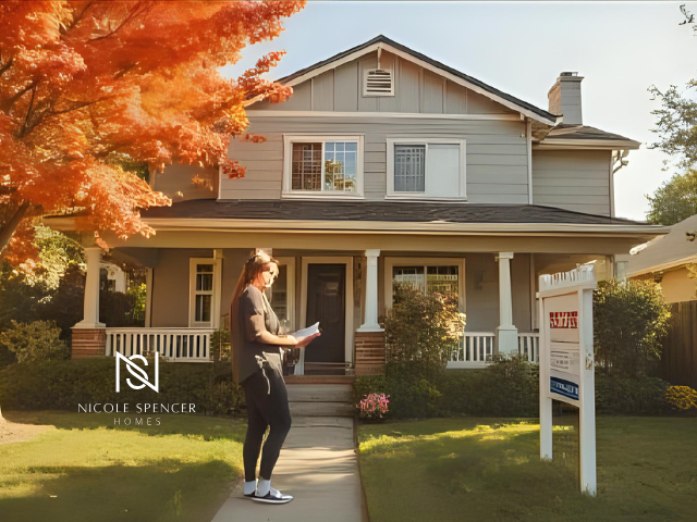 Woman looking at documents in front of a house with 