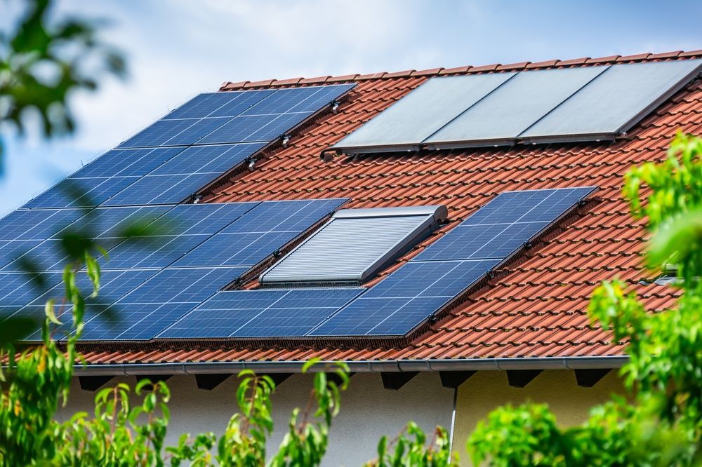 A house with solar panels on the roof and a skylight.