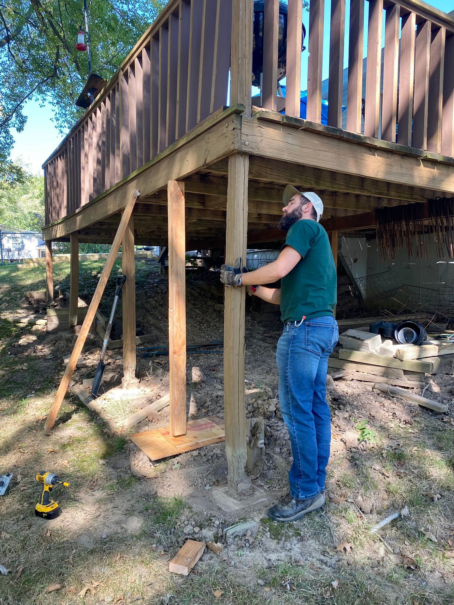 A man is working on a wooden deck.