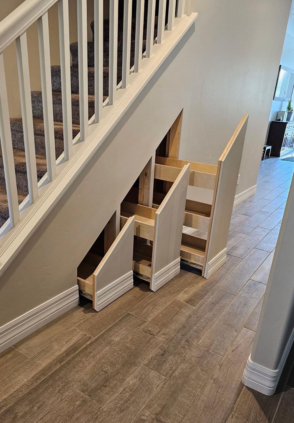 A staircase with a drawer underneath it.