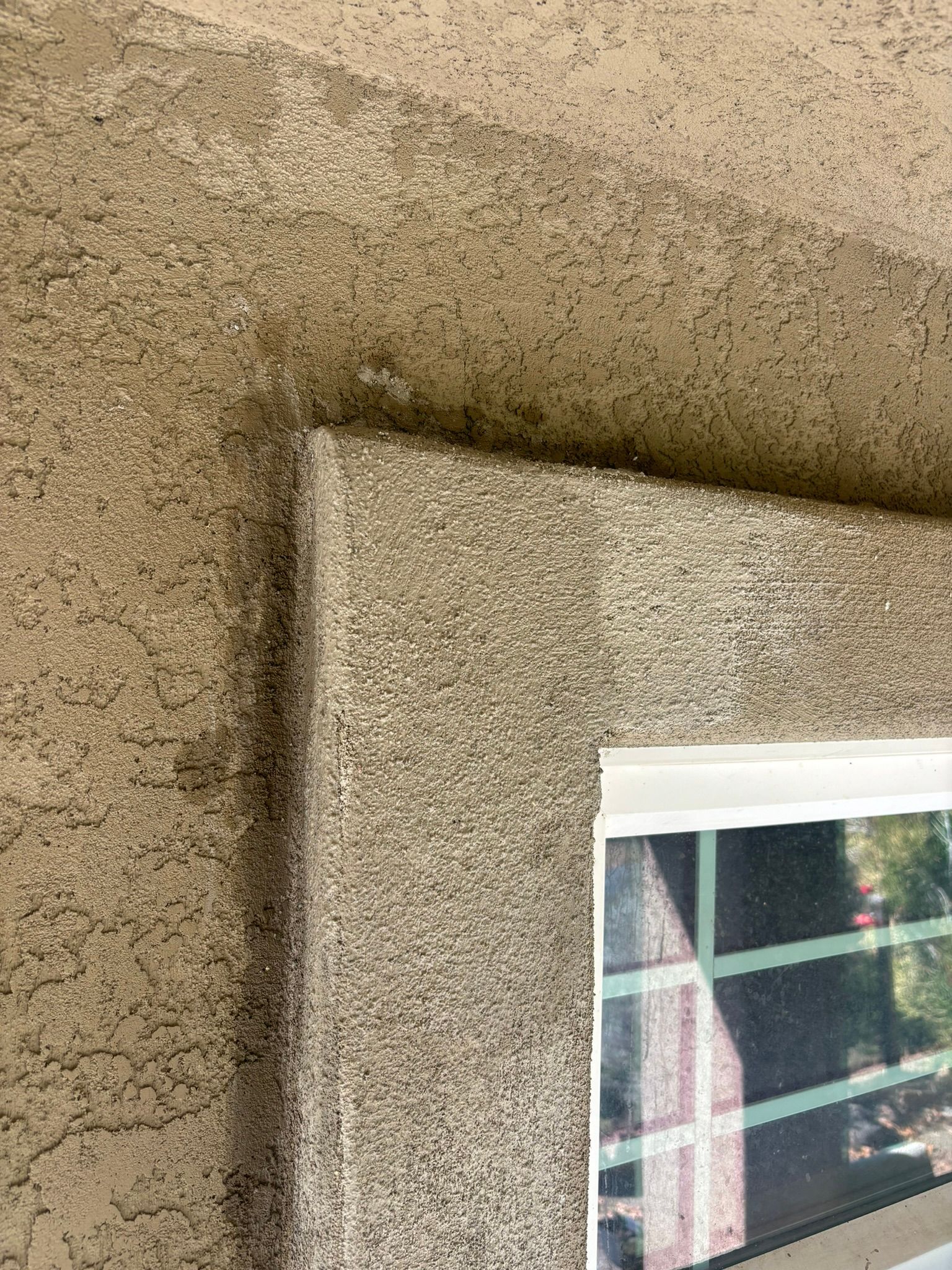 A close up of a wall with a picture of a window on it.