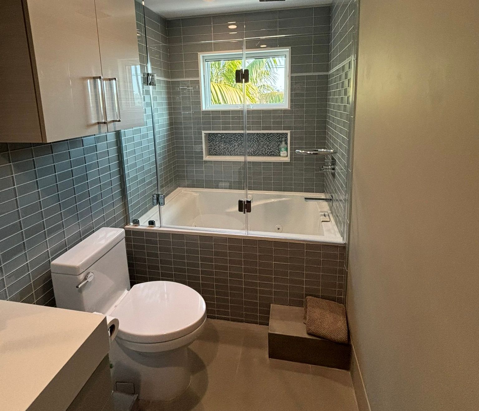 A bathroom with a toilet , tub and shower.