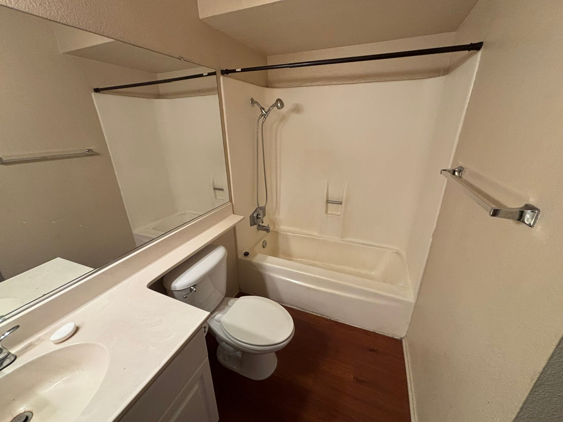 A bathroom with a toilet , sink and bathtub