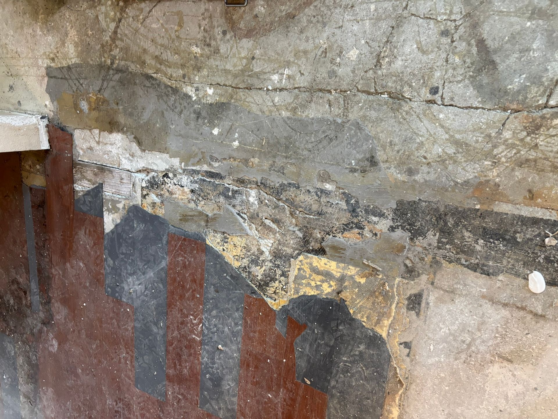 A close up of a wall with a painting on it.