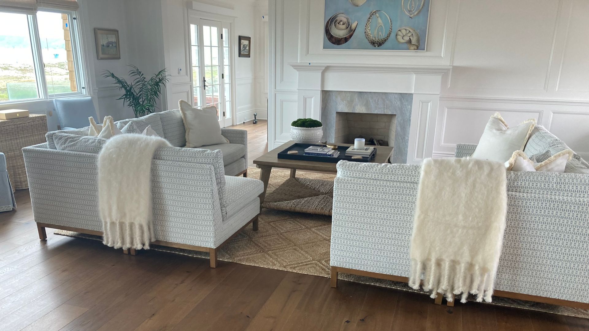 A living room with a staircase leading to the second floor