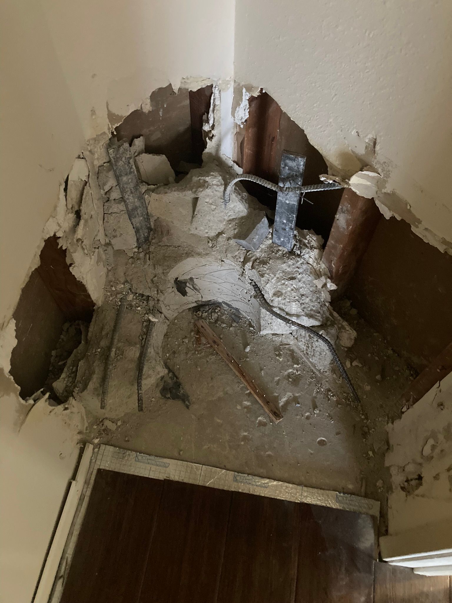 There is a hole in the wall in the corner of the room.