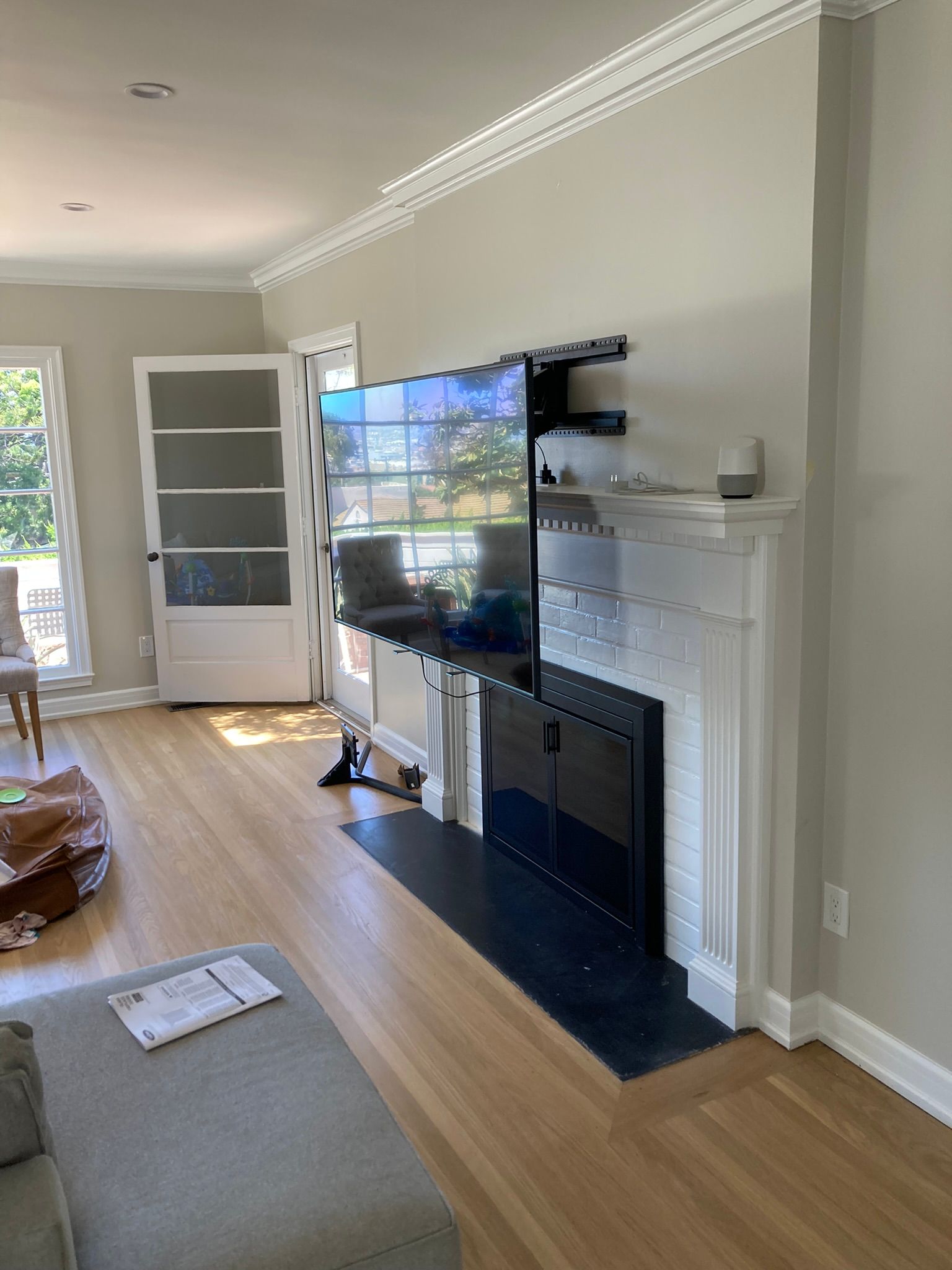 A living room with a fireplace and a flat screen tv mounted on the wall.