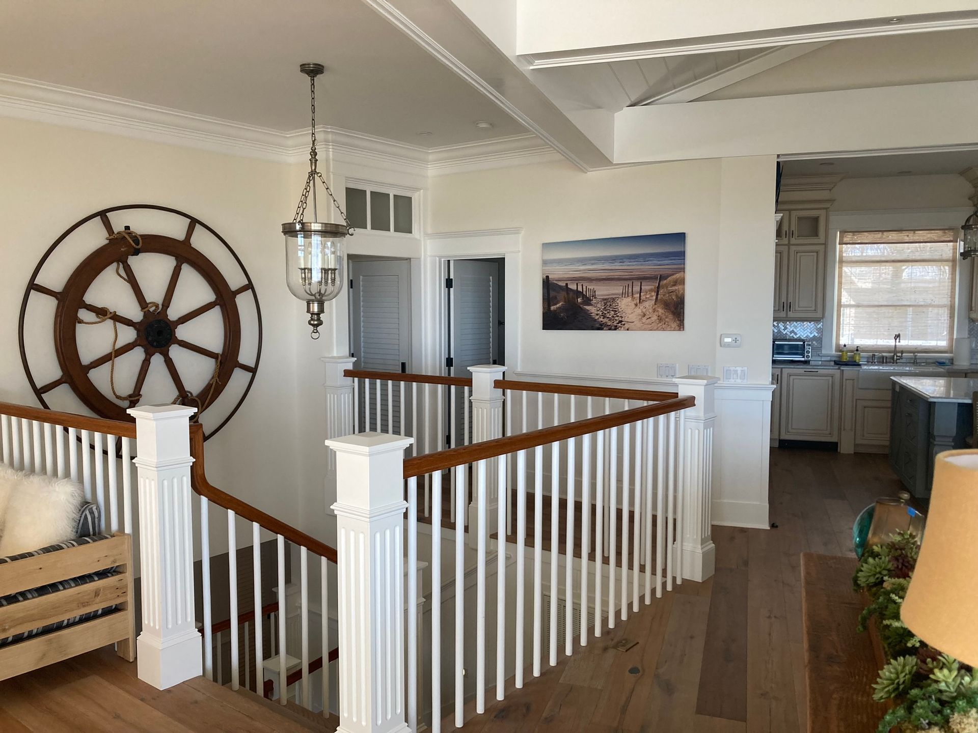 A living room with a staircase and a picture on the wall