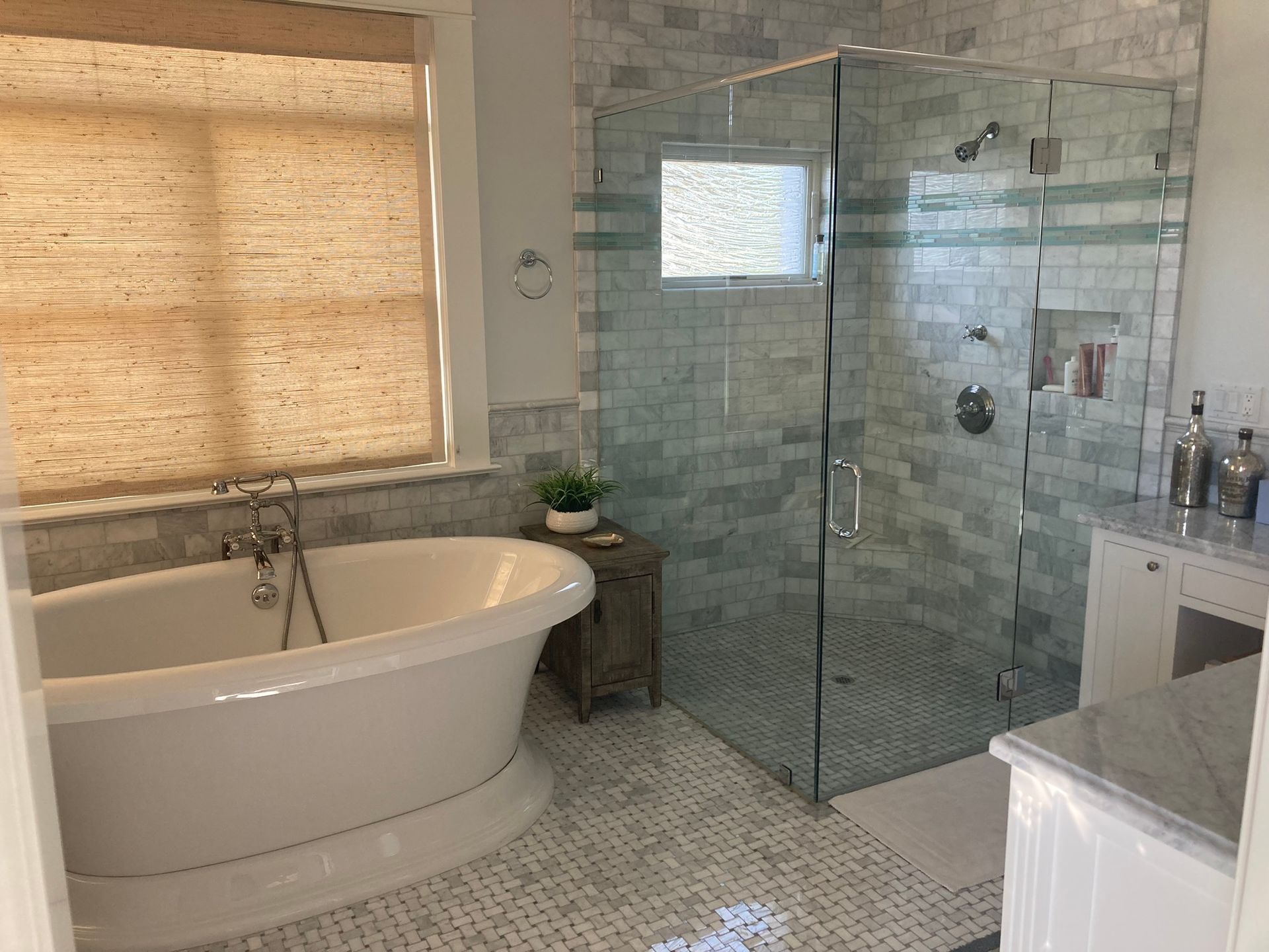 A bathroom with a tub and a walk in shower.