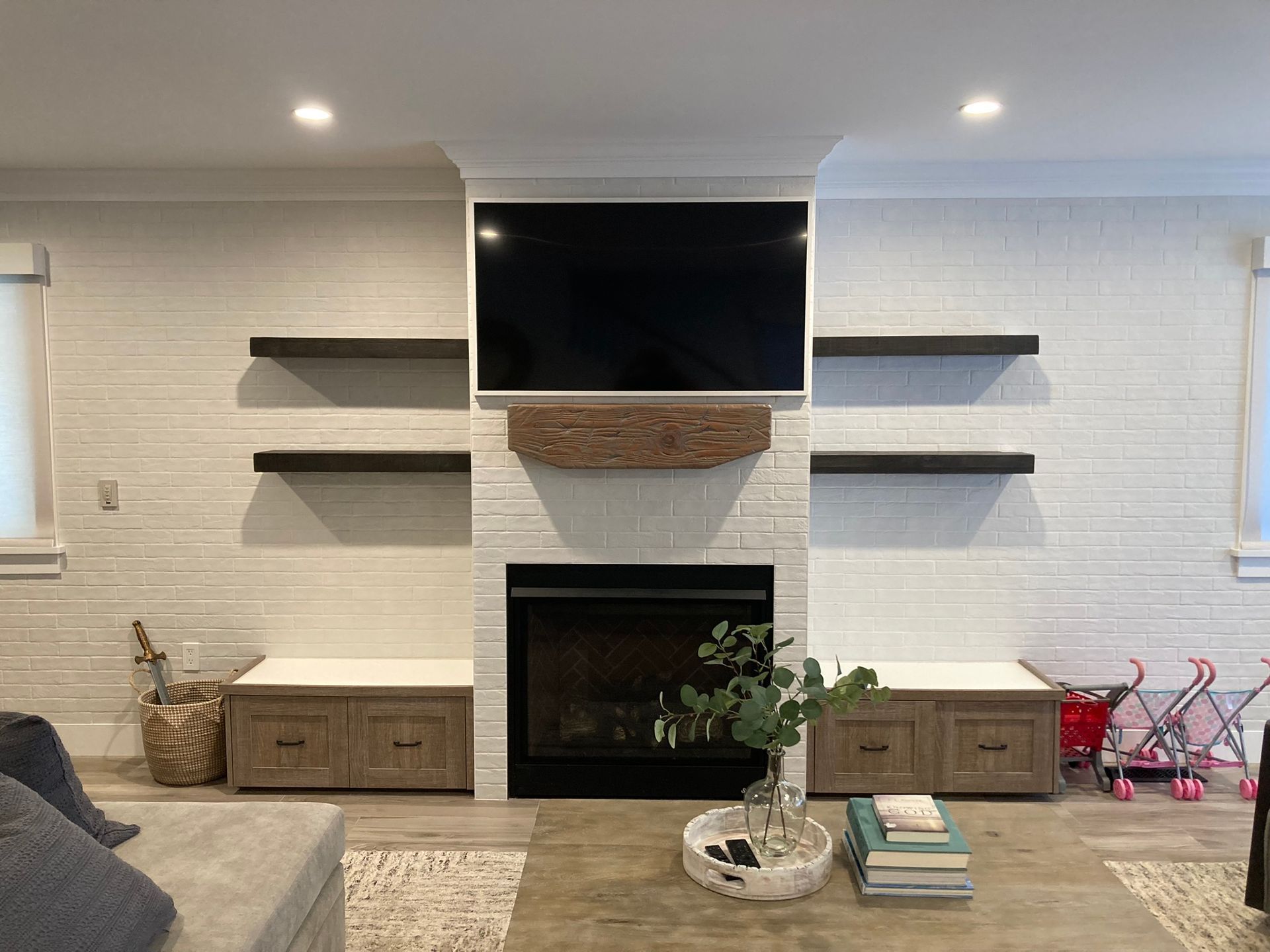 A living room with a fireplace and a flat screen tv.