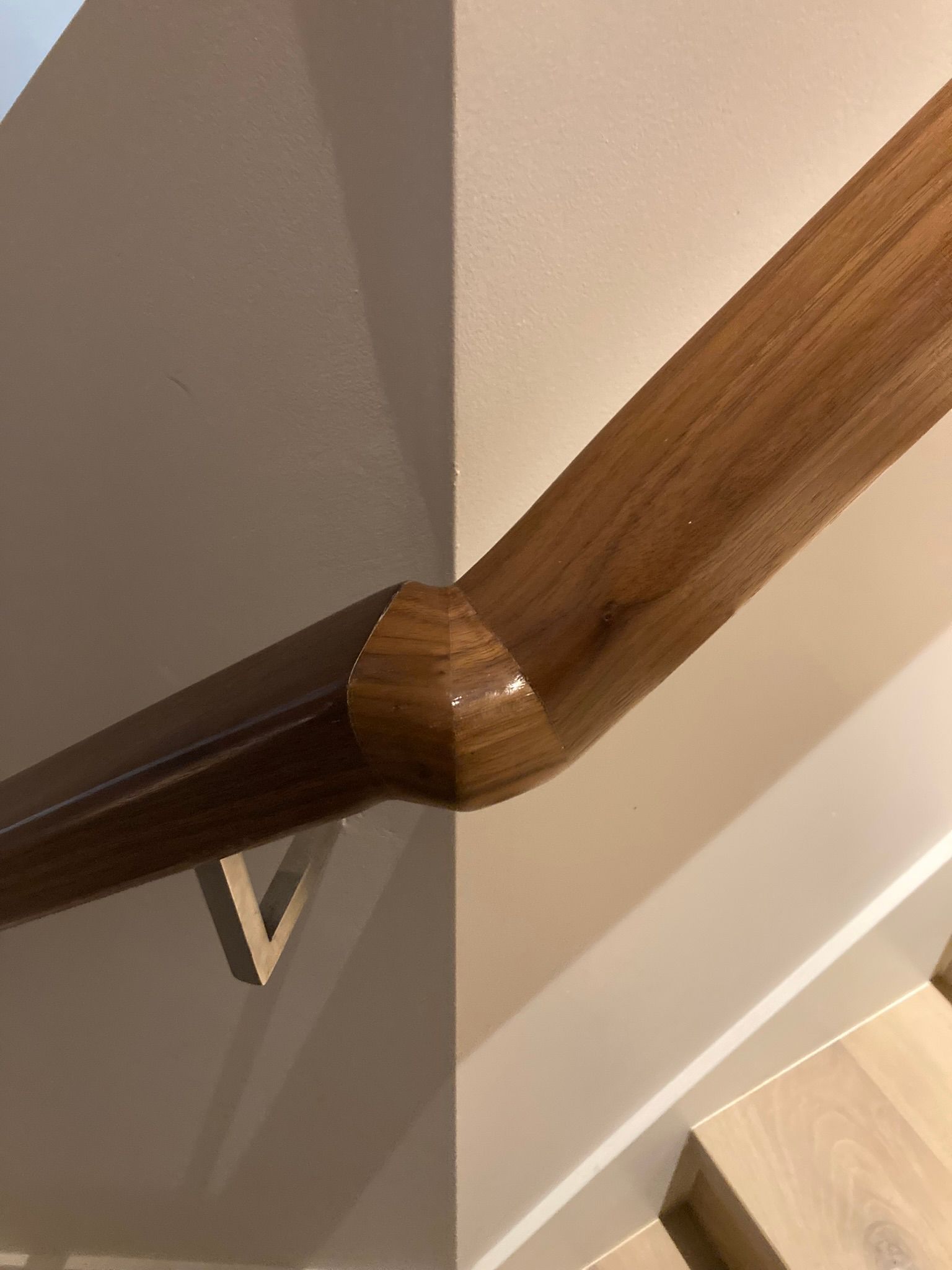 A close up of a wooden handrail on a staircase.