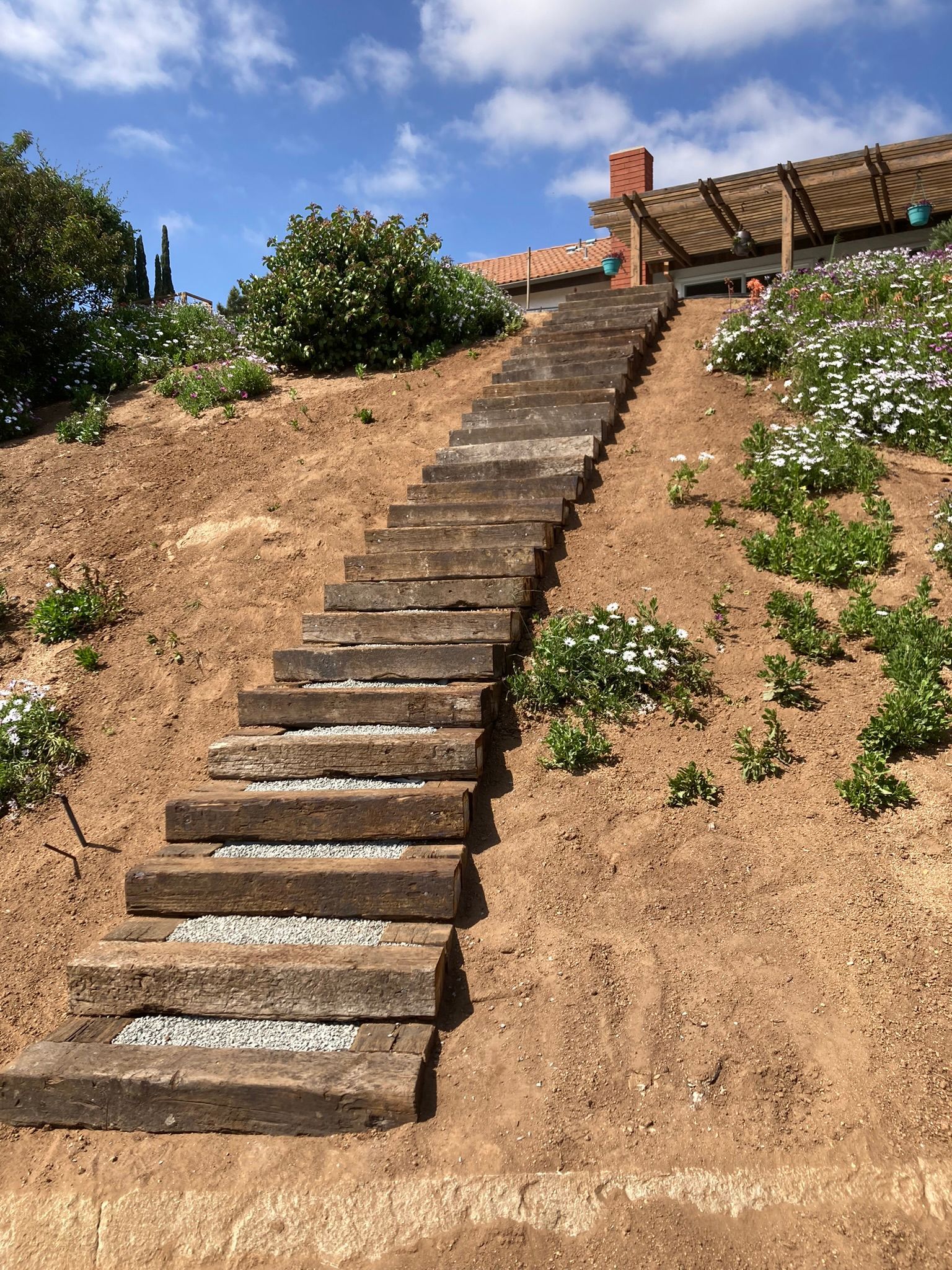 A set of wooden stairs going up a hill.