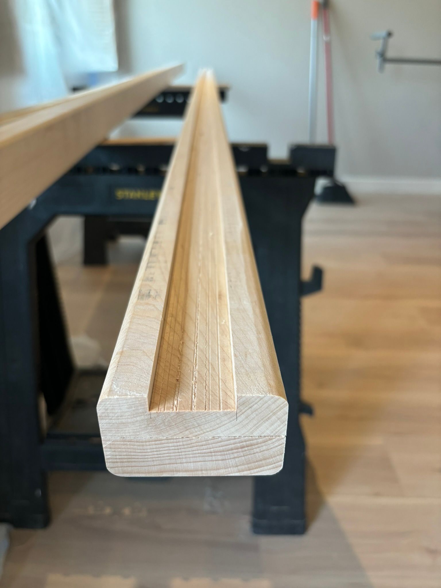 A piece of wood is sitting on top of a wooden table.