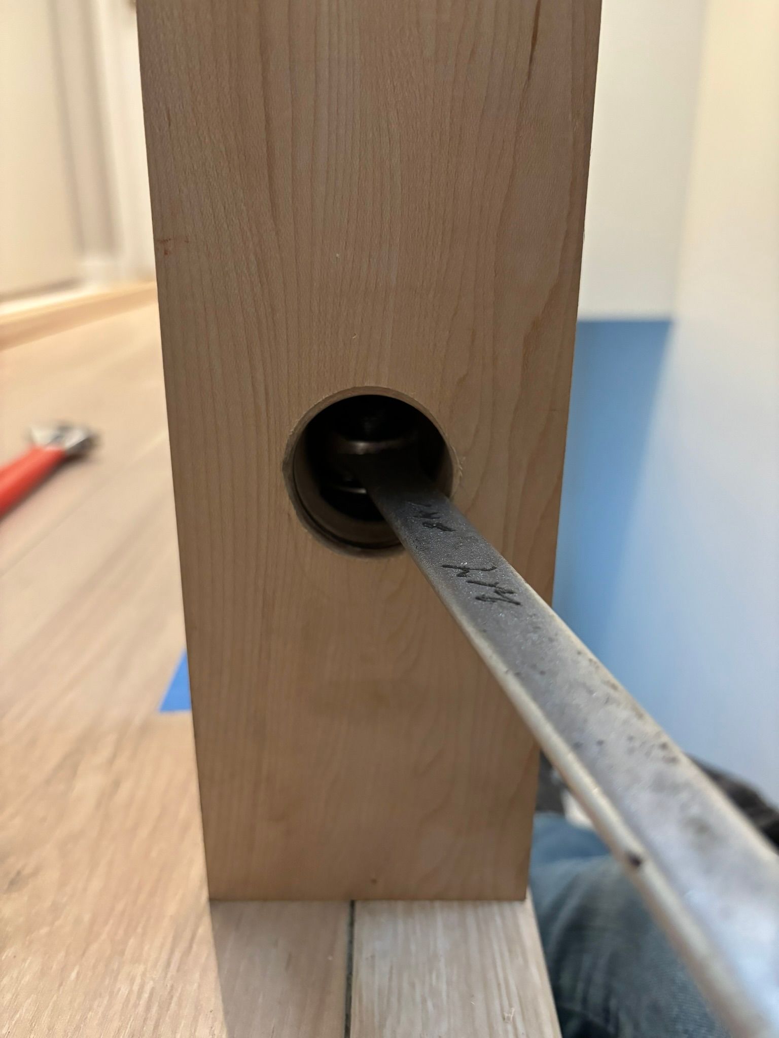 A chisel inserted into a door's lock hole, woodworking.
