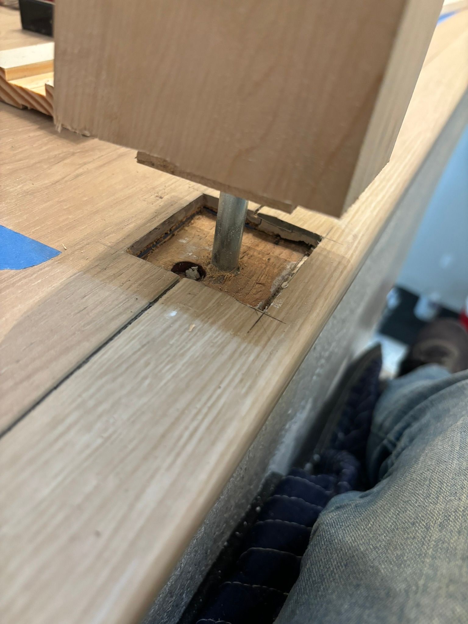 A piece of wood is sitting on top of a wooden table.