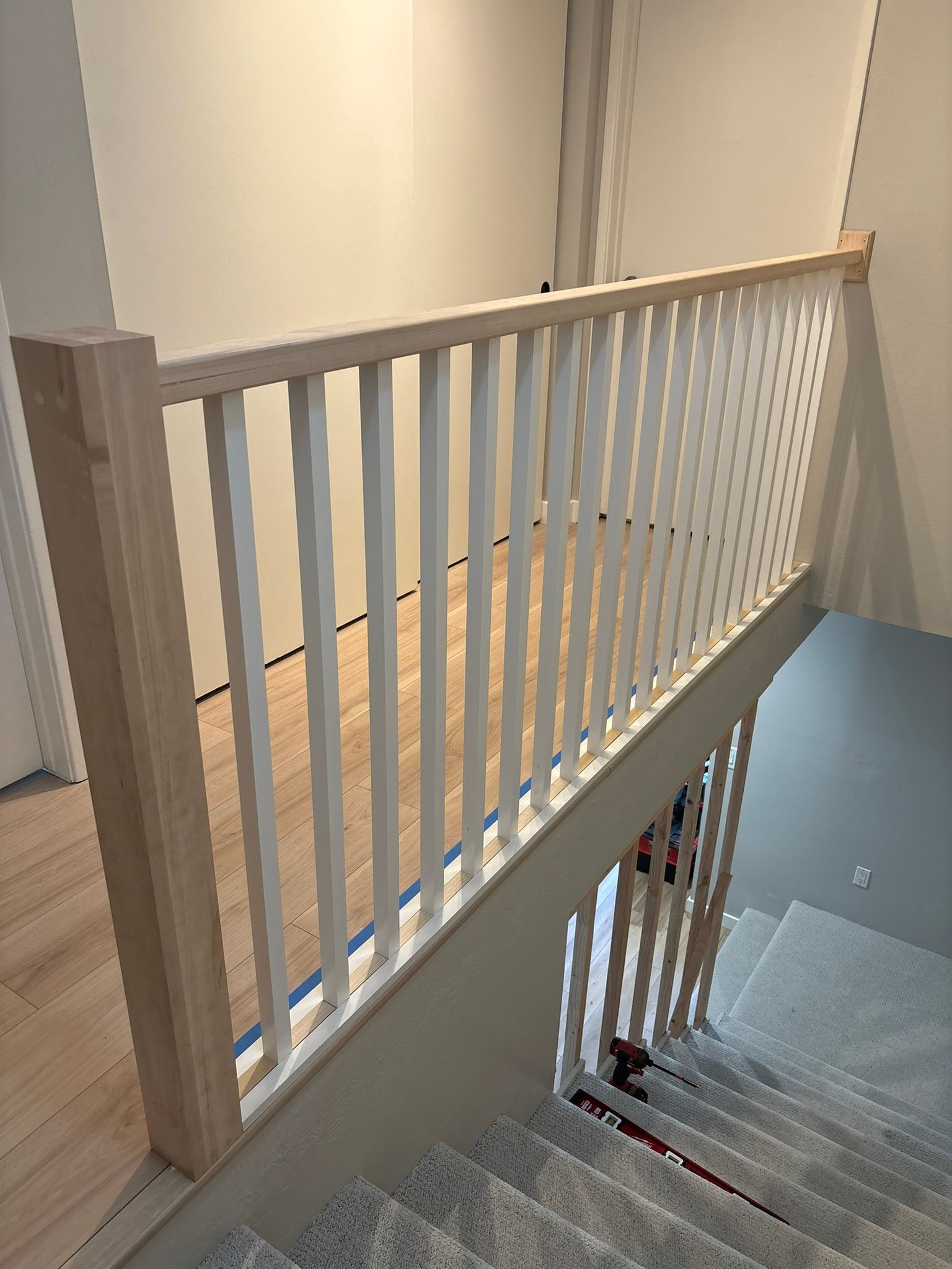 A wooden railing on a set of stairs in a house.