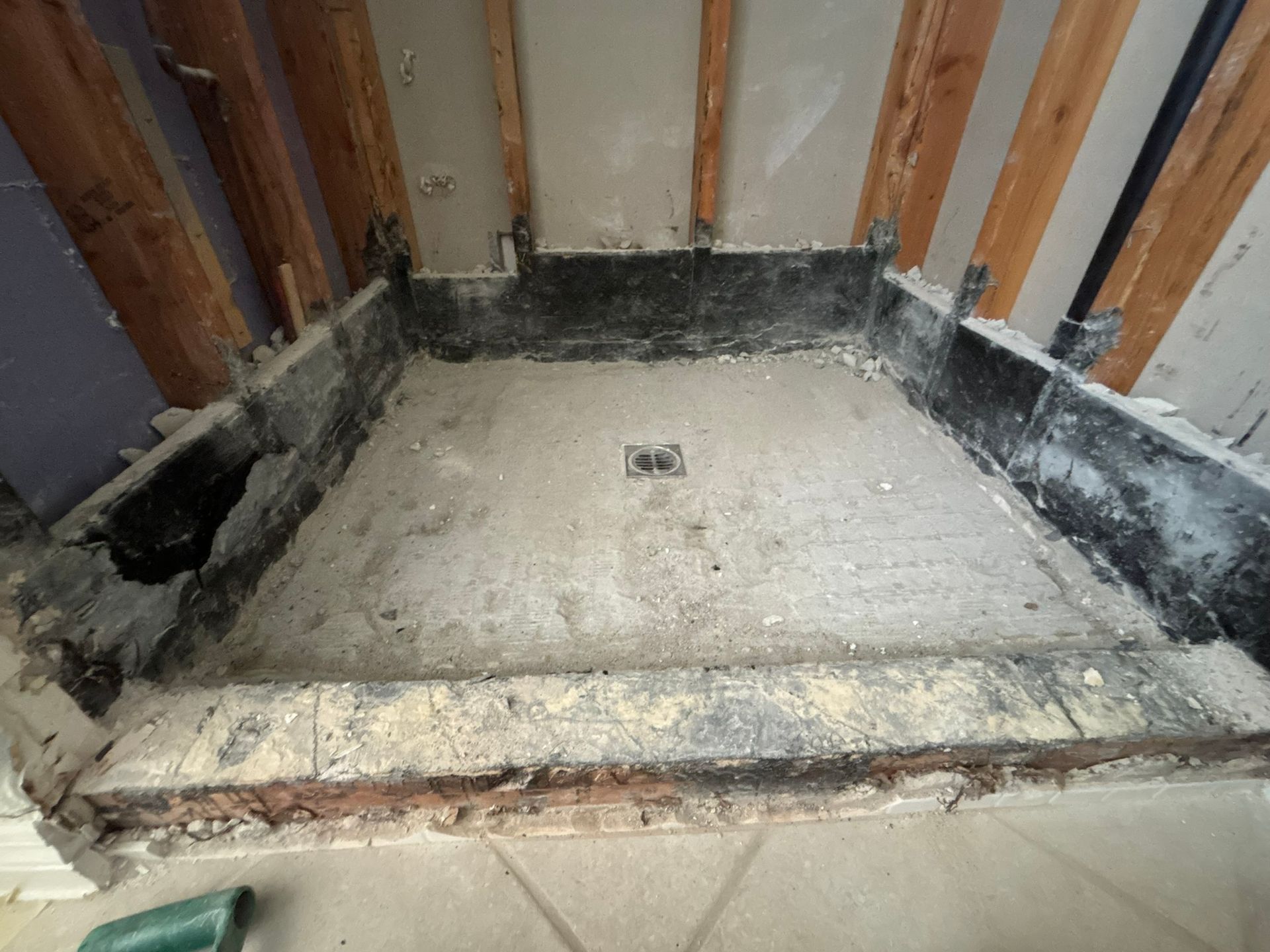 A shower stall is being remodeled in a bathroom.