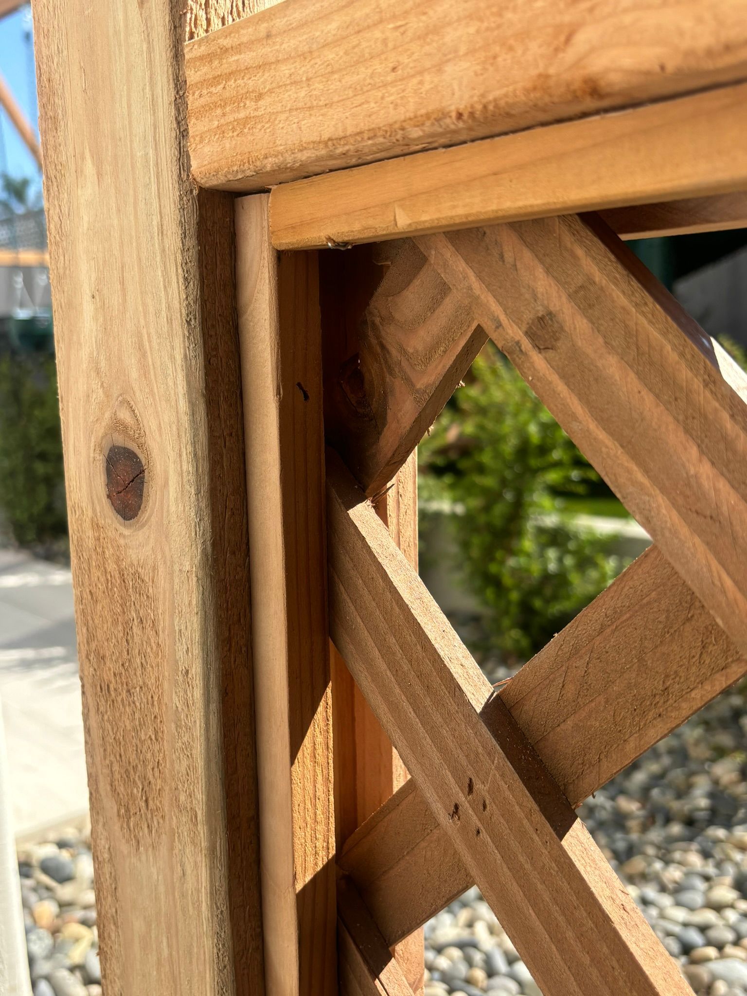 A close up of a wooden structure with a fence in the background.