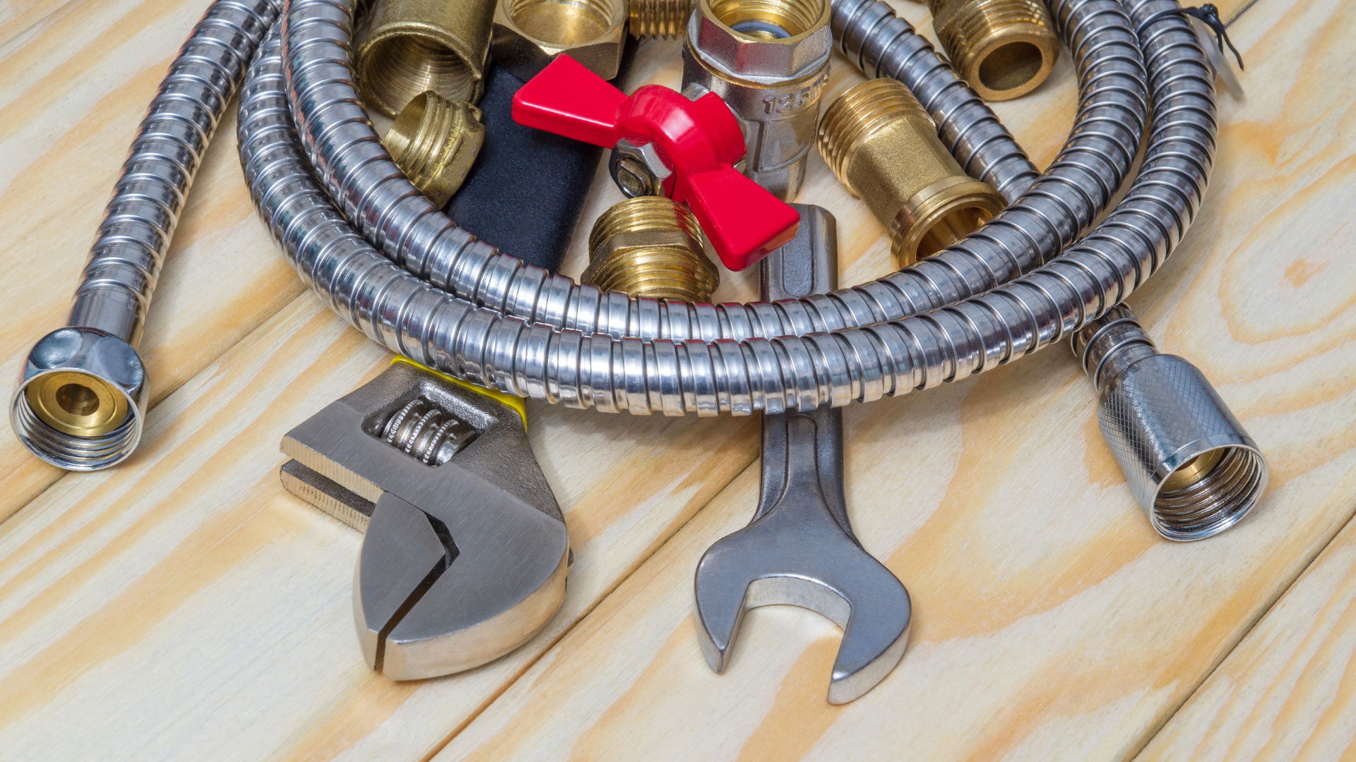 A wall with a lot of copper pipes coming out of it.