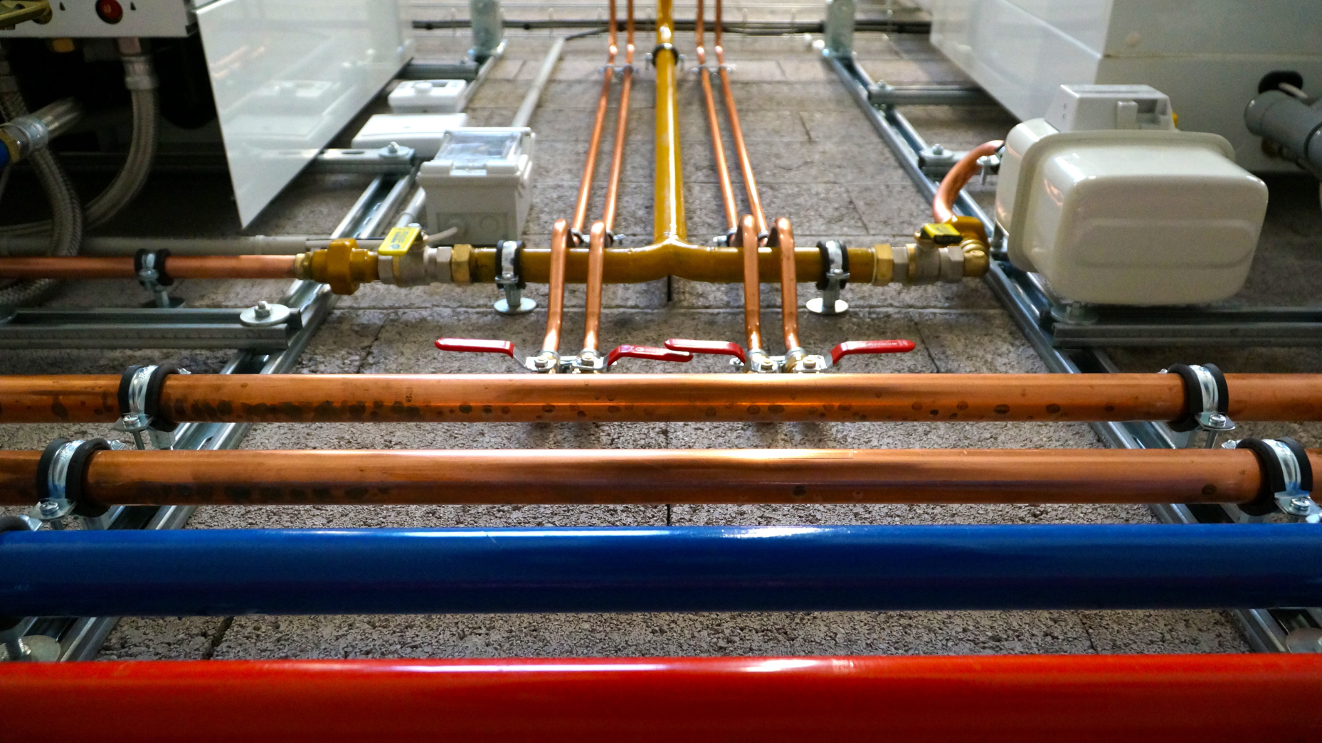 A person is working on a pipe with a wrench.