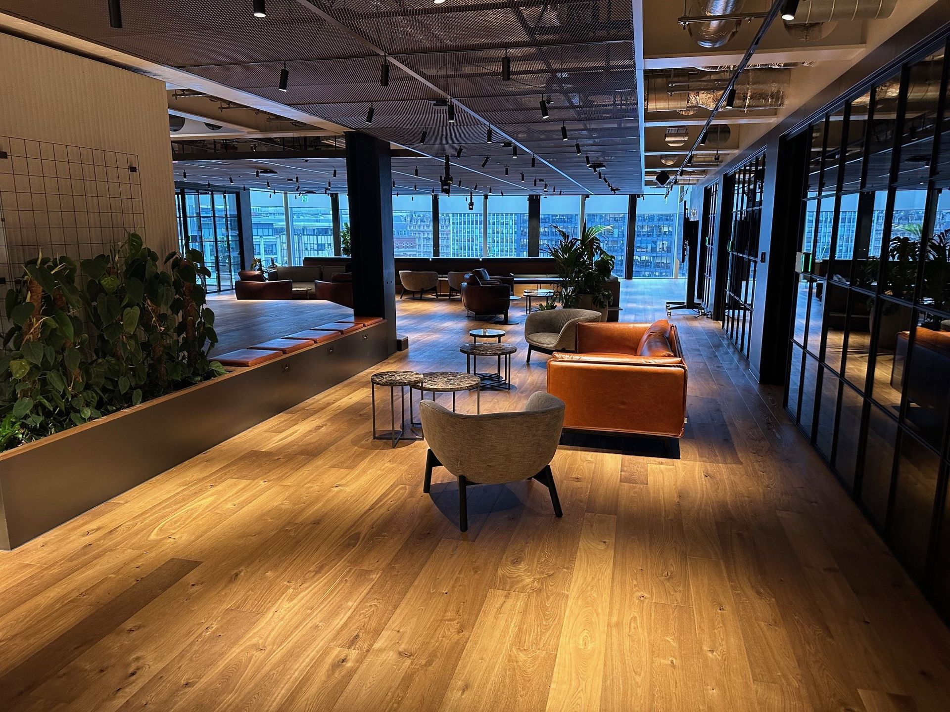 A large room with wooden floors and lots of furniture.