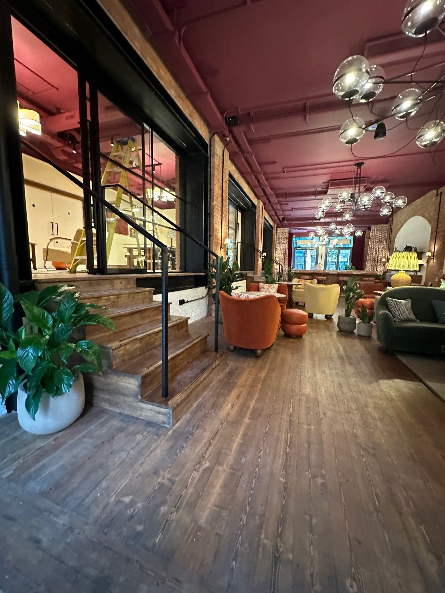 A large room with wooden floors and a purple ceiling.