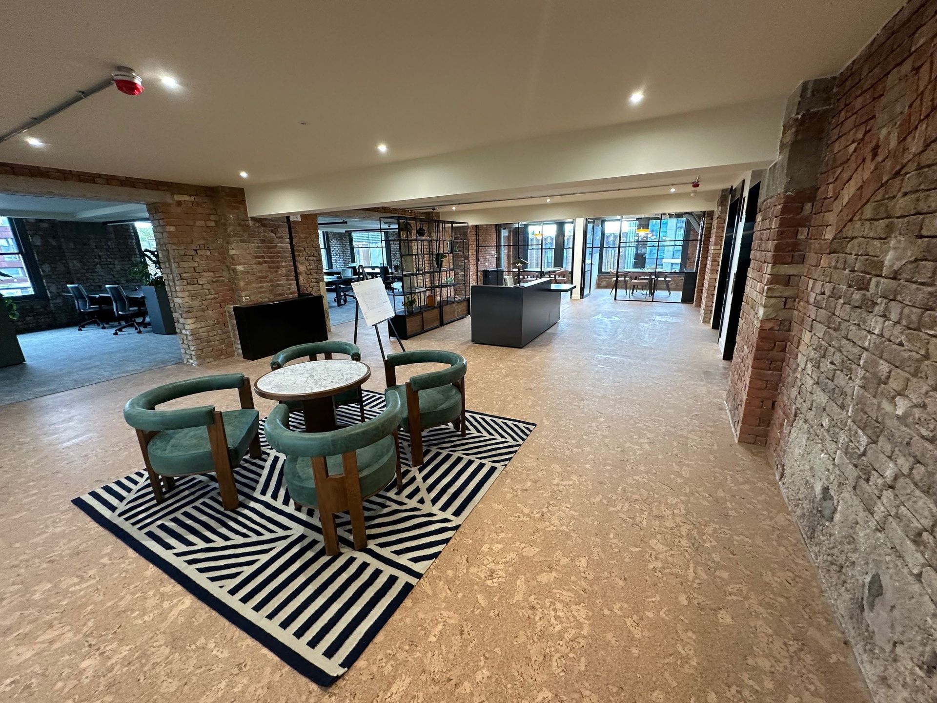 There is a table and chairs in the middle of the room.