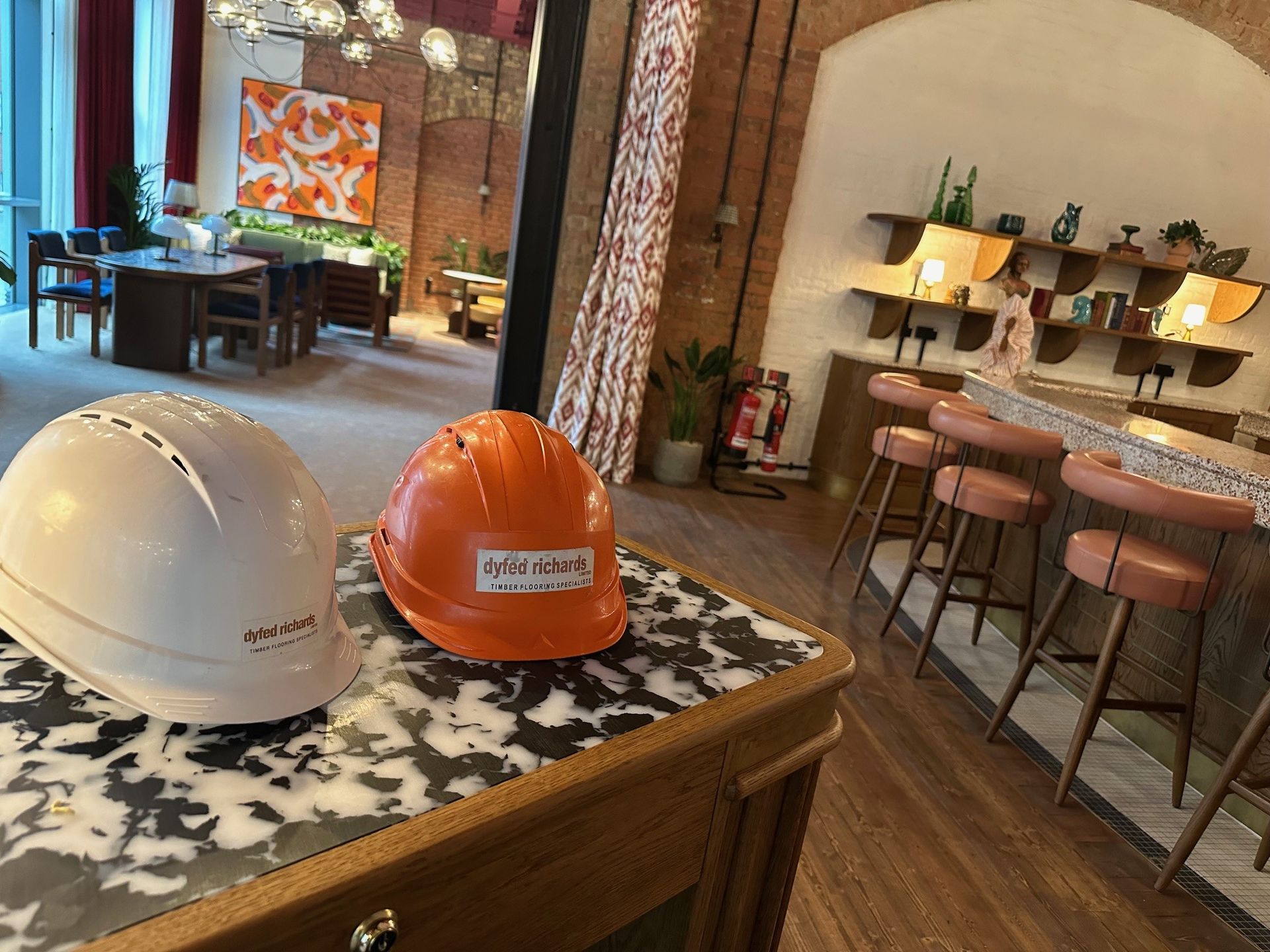 Two hard hats sitting on a table 