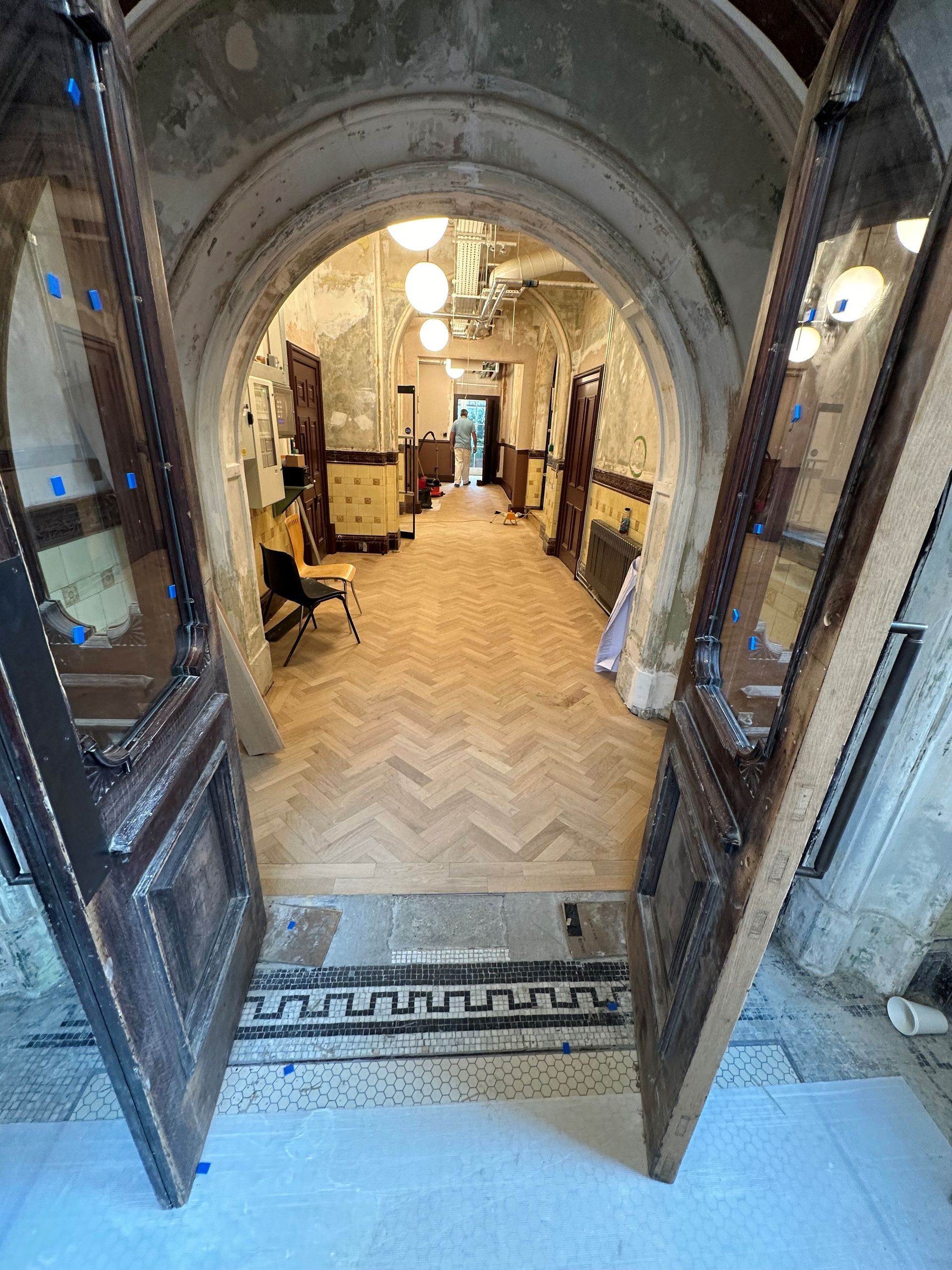 archway leading to a corridor with a wooden floor walworth townhall