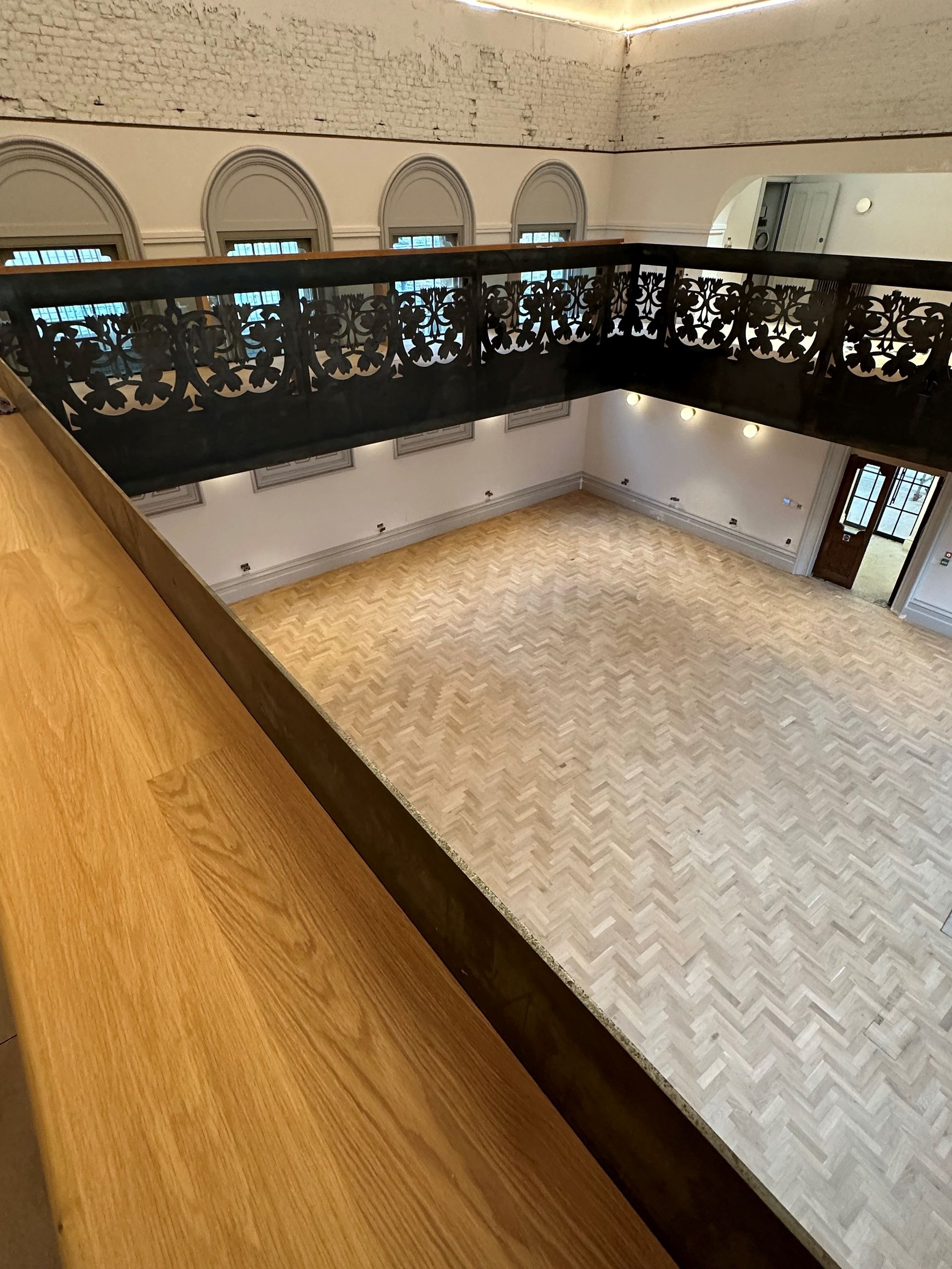 dark wood ornate balcony with a wooden floor below in walworth town hall