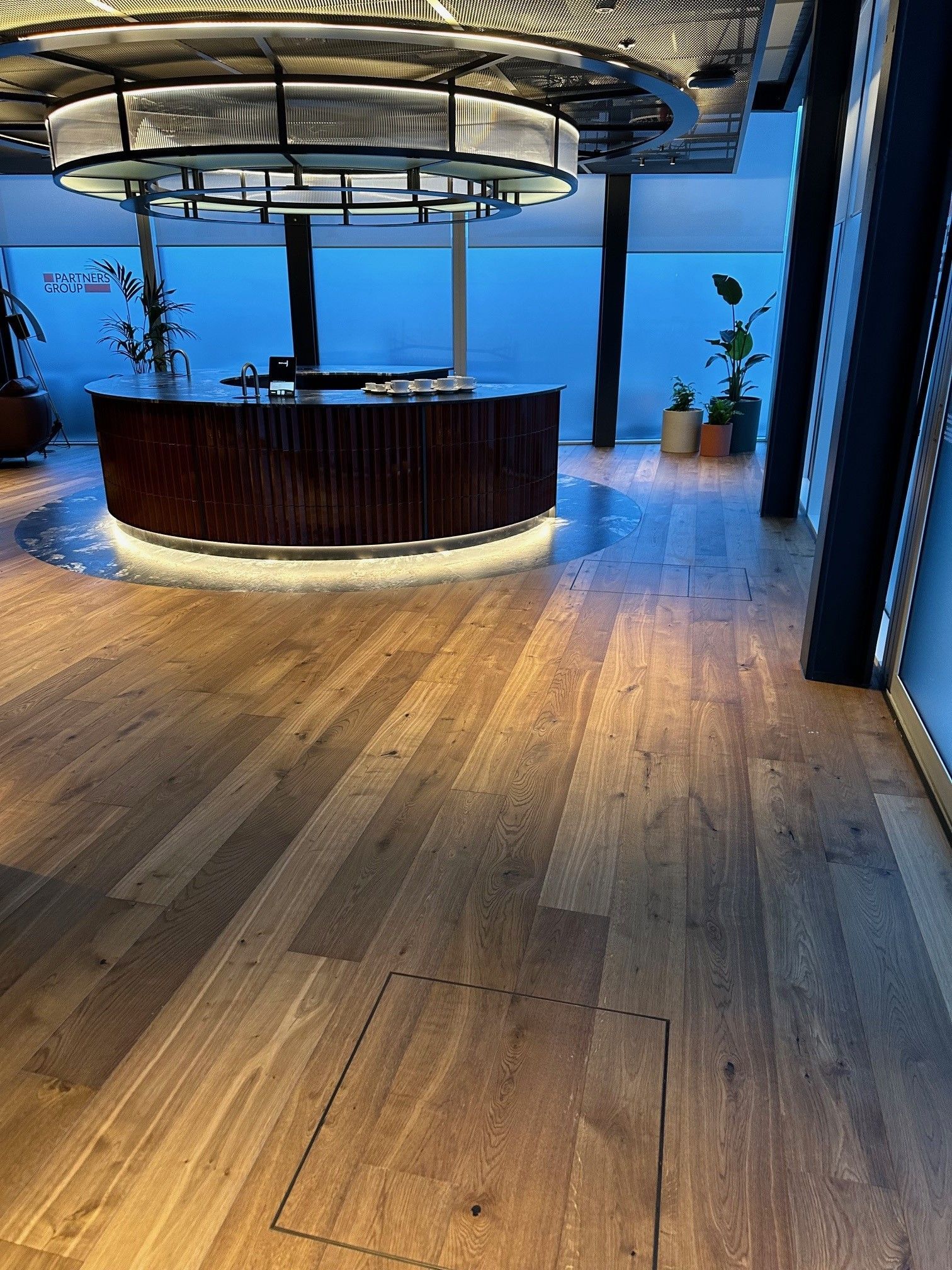 A wooden floor with a round counter in the middle of the room.