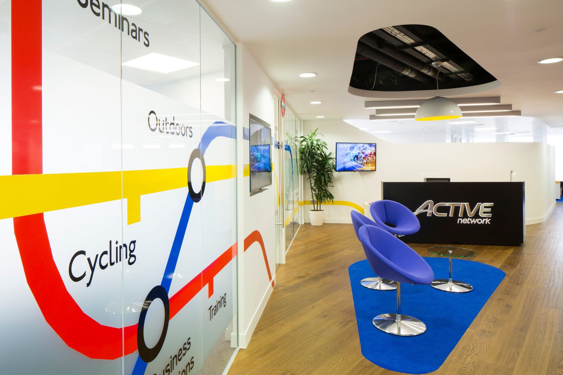 shot of reception area fitted with 
Stained & Lacquered Flooring at Active Network against wall