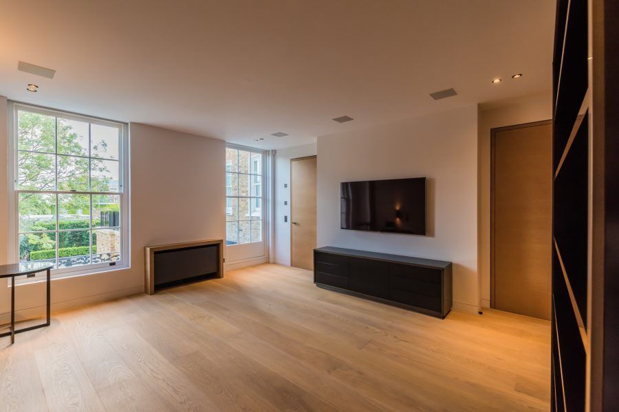 Unfurnished lounge at Private Residence in Kensington finished with bespoke oil flooring