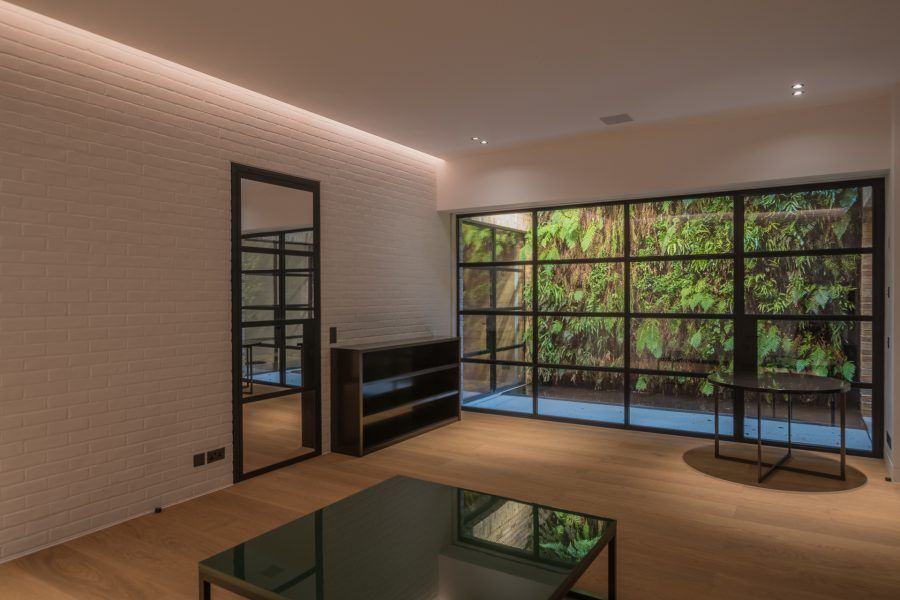 Room with large glass panels finished with a Bespoke Oil flooring at Private Residence in Kensington