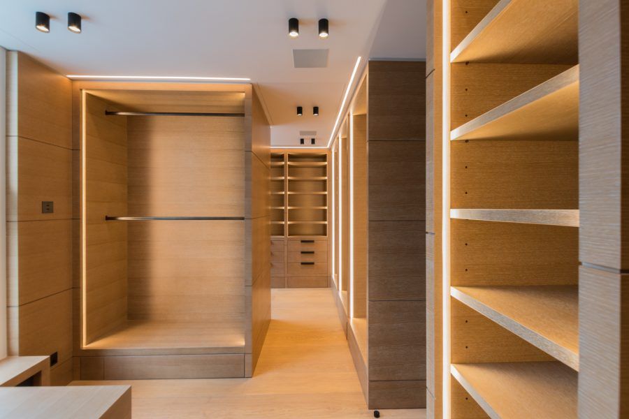 Walk in closet at Private Residence in Kensington fitted with a Bespoke Oil flooring