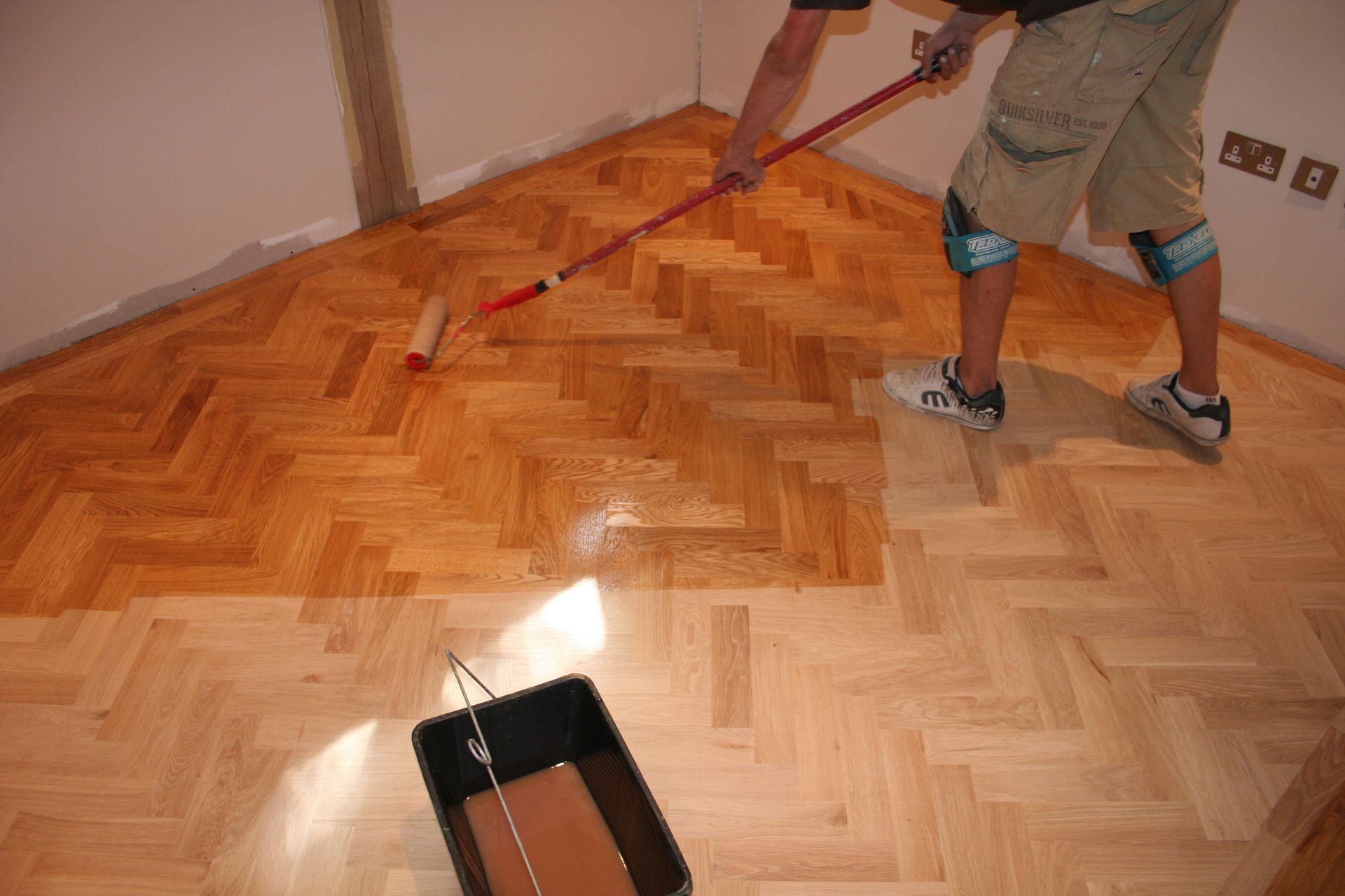 Wooden Flooring Getting Treated With A Roller Wooden Flooring Getting Treated