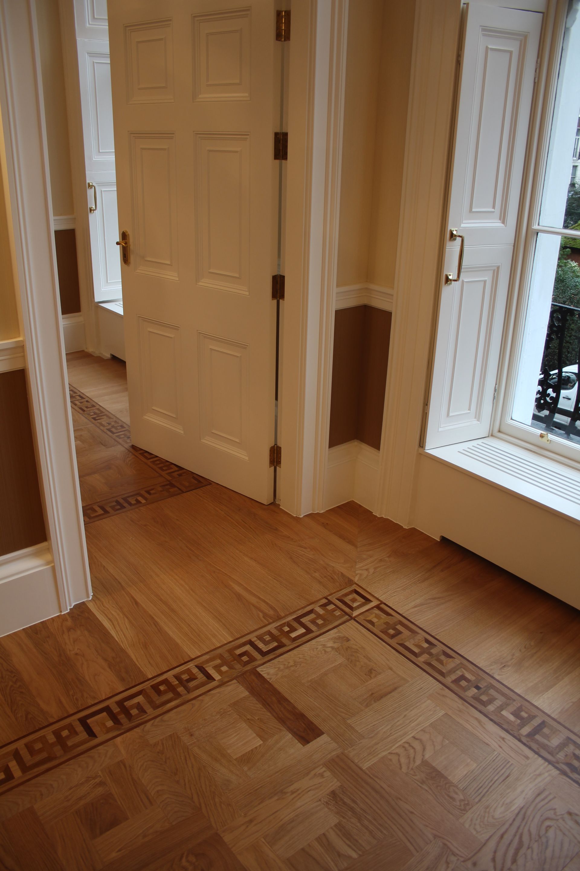 Prime Grade Oak Parquet complicated flooring design between rooms at a private residence in Baker Street, London