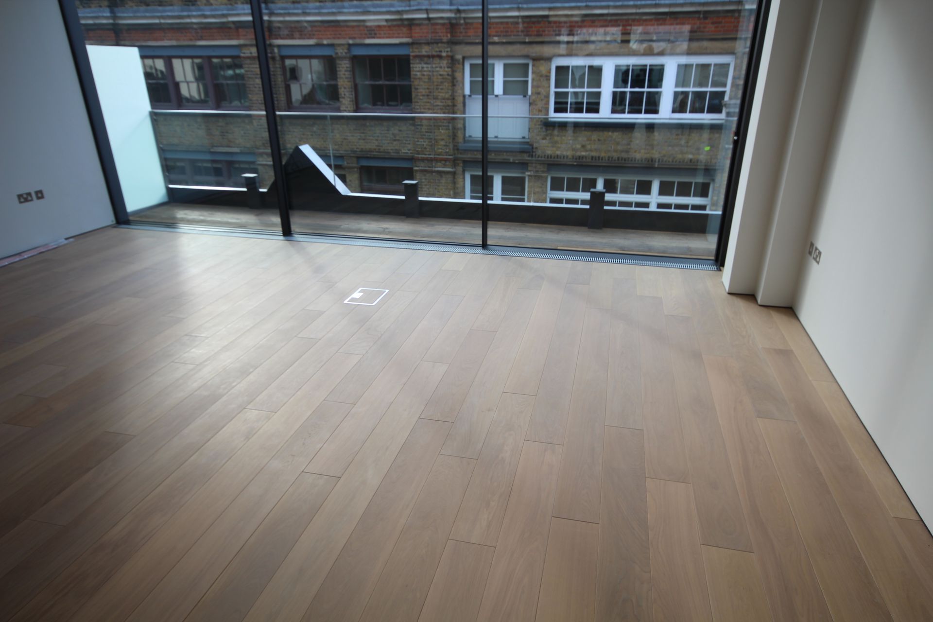 Large windows in room with Prime Grade Oak with Light White Oil flooring at residence in Charlotte Street, London