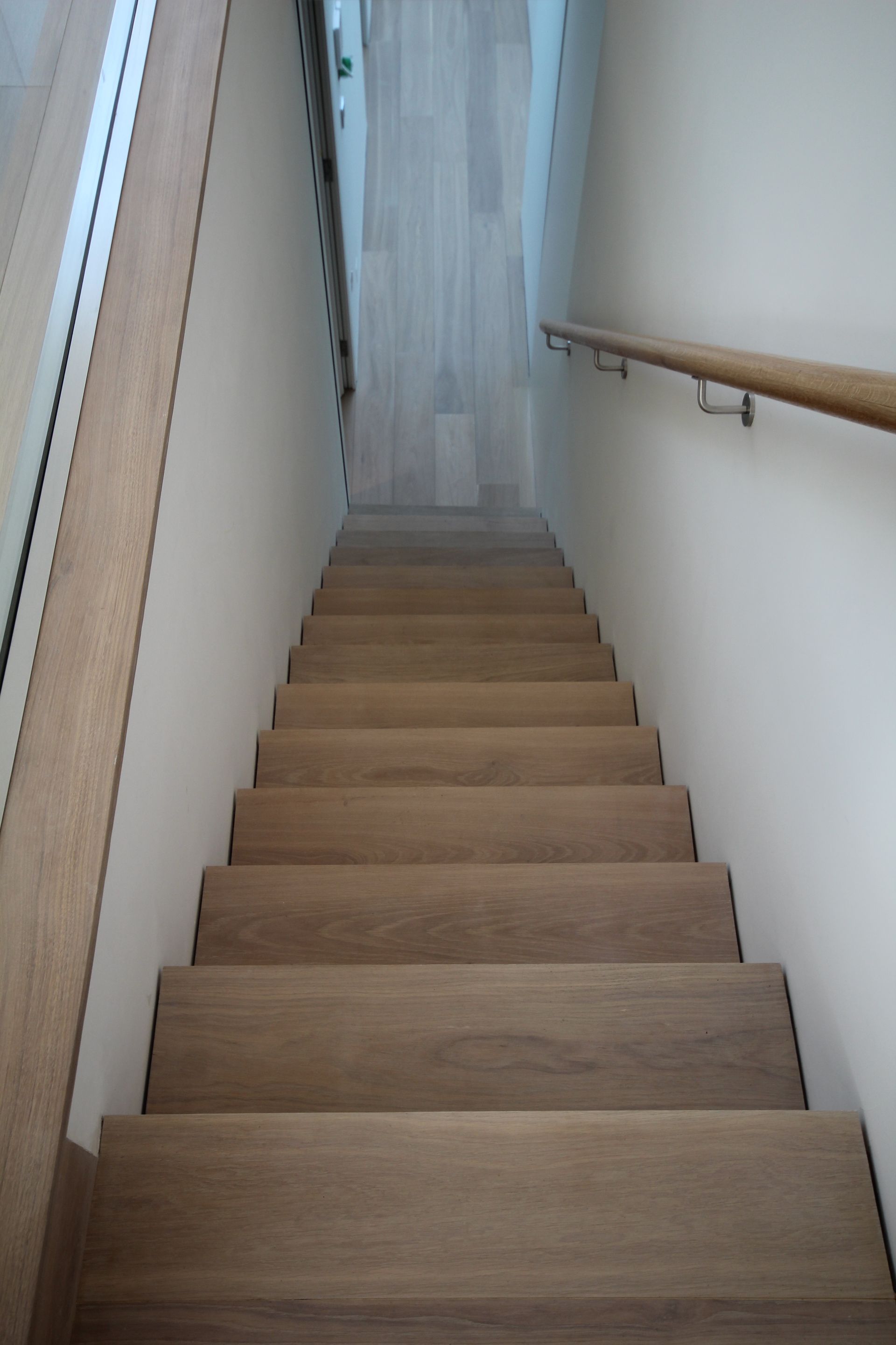 Staircase cladded with Prime Grade Oak with Light White Oil at residence in Charlotte Street, London