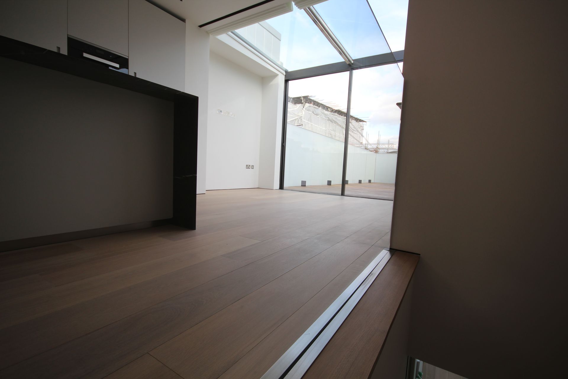 Top of stairs fitted with Prime Grade Oak with Light White Oil flooring at residence in Charlotte Street, London