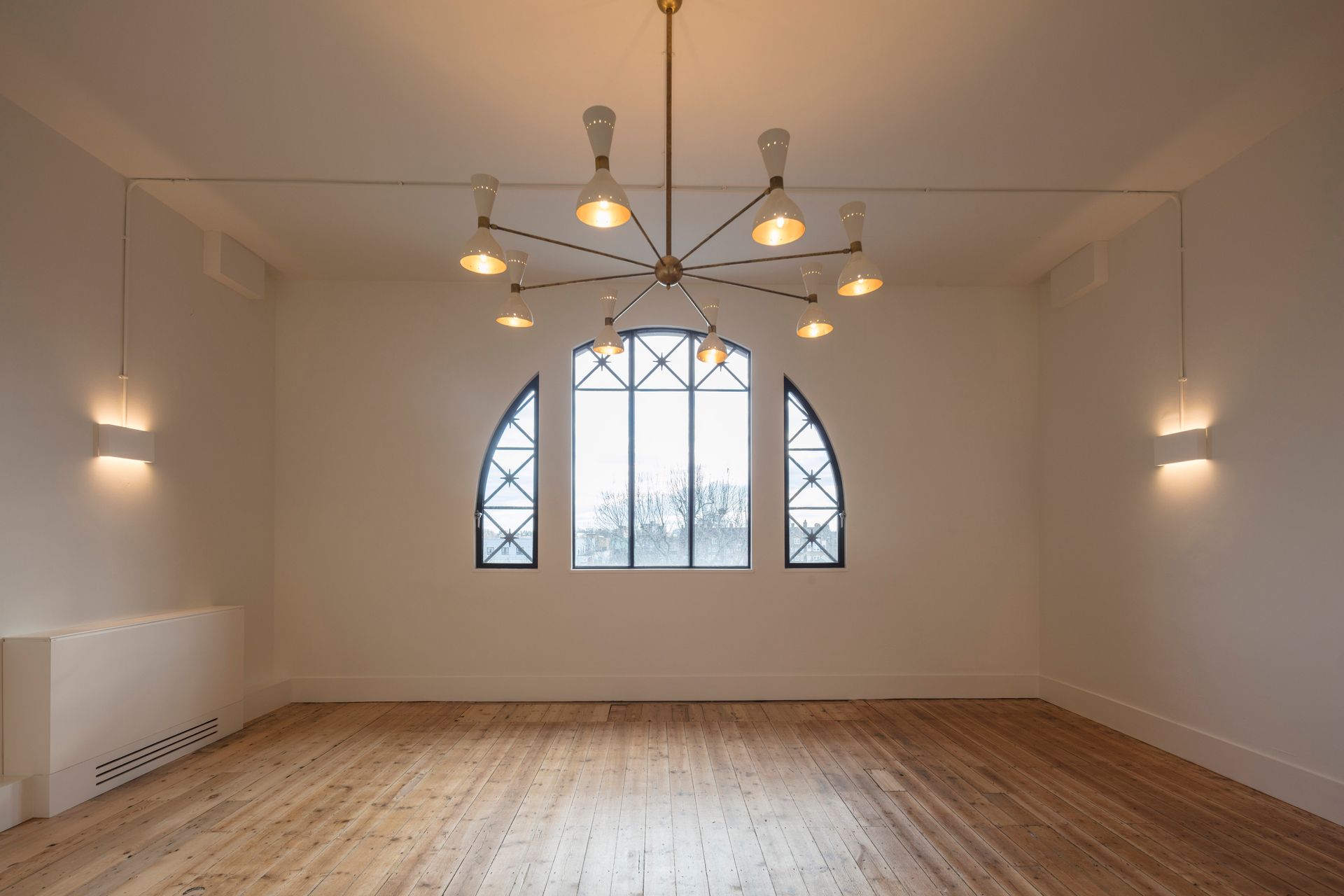 Unfurnished Room with chandelier at Department W fitted with a Clear Polyurethane Lacquer floor