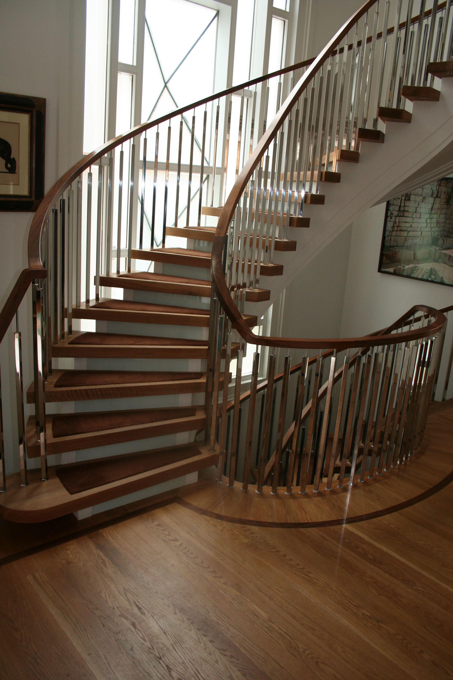 A spiral staircase with wooden steps and a metal railing