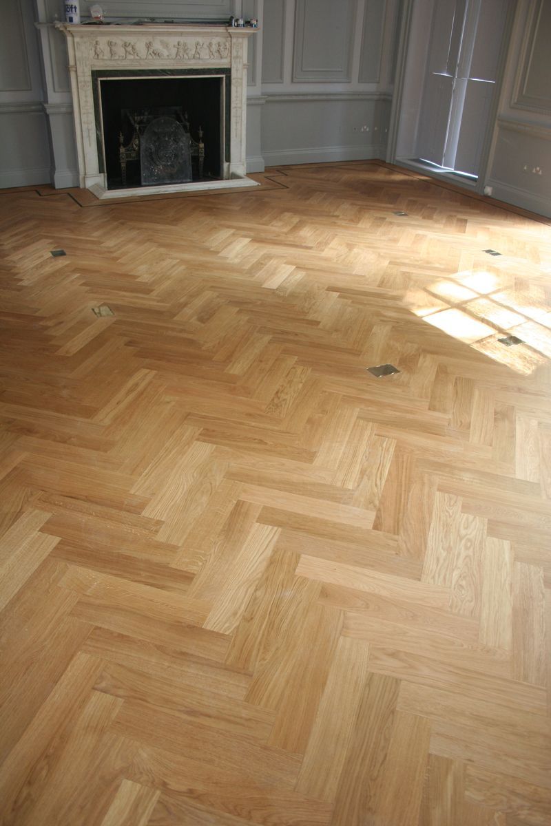 Oak Parquet hardwood floor, light brown, angled, with sunlight.