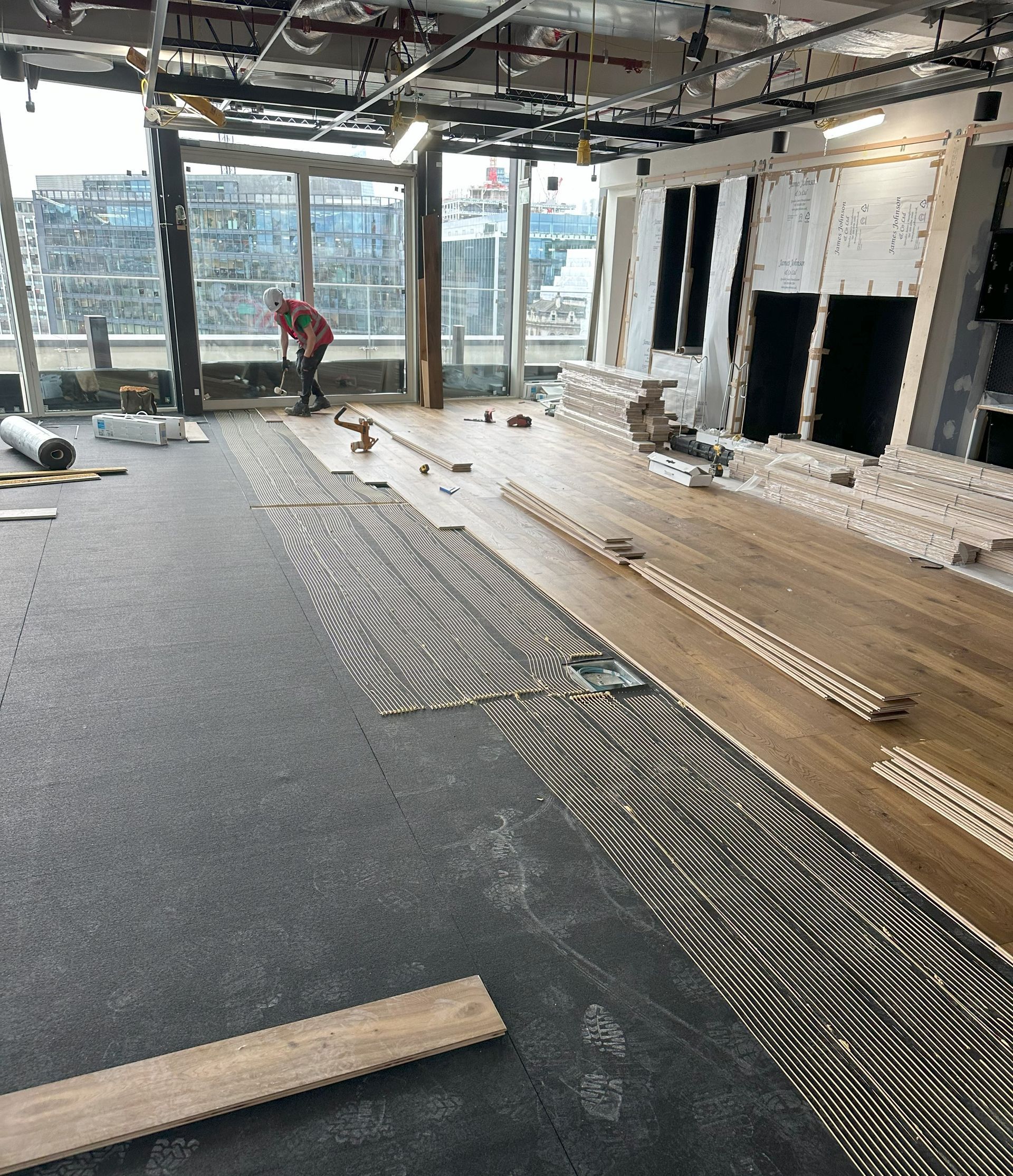 Dyfed Richards Applying Underlay Glue before Installing Flooring