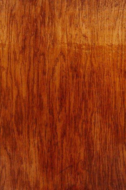 Wood grain surface with vertical lines, showing reddish-brown and lighter tones.