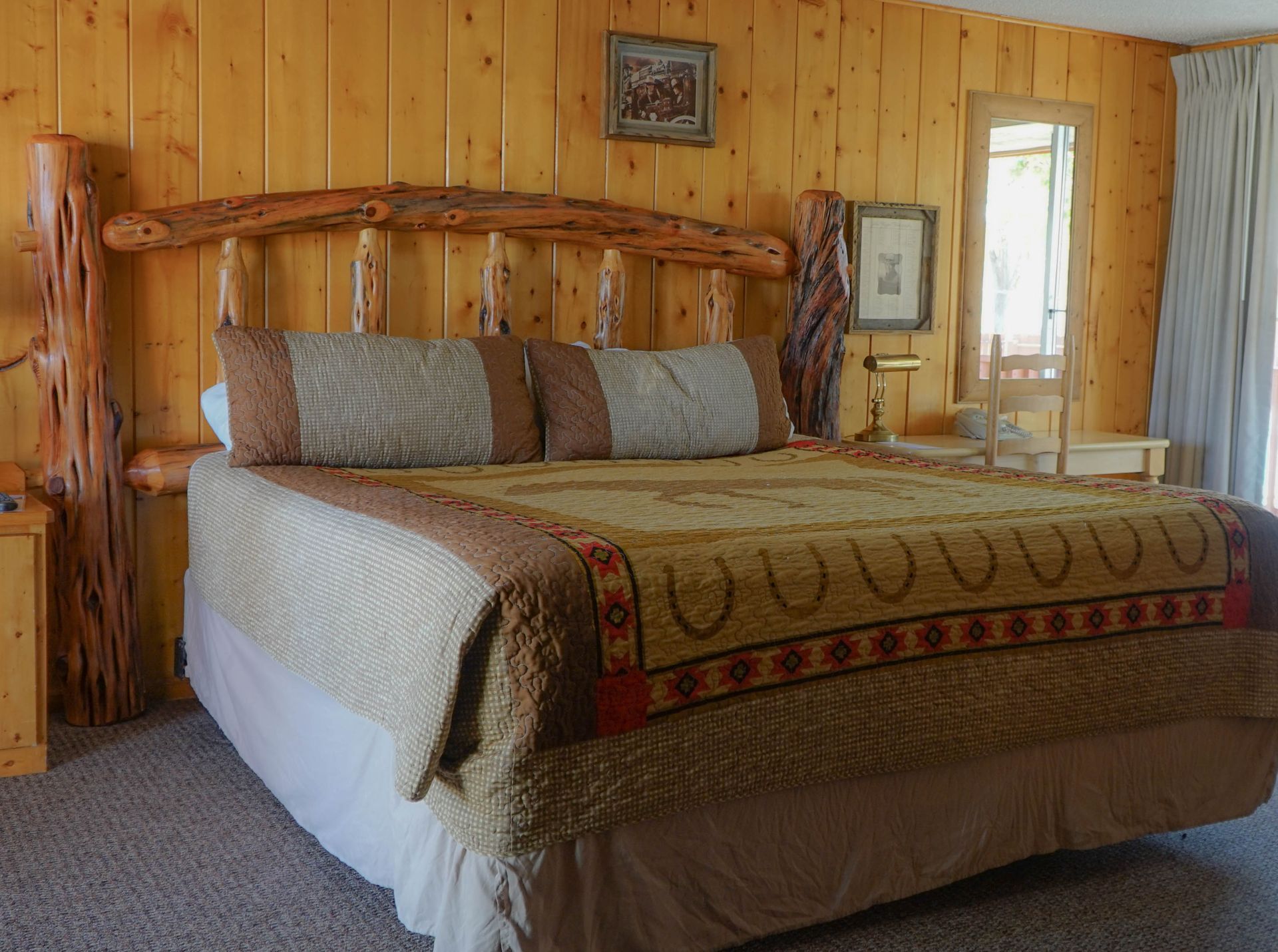 A bedroom with a king size bed and a wooden headboard.