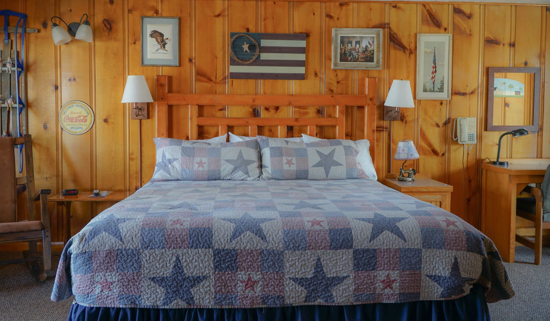 A bedroom with a king size bed and a wooden wall