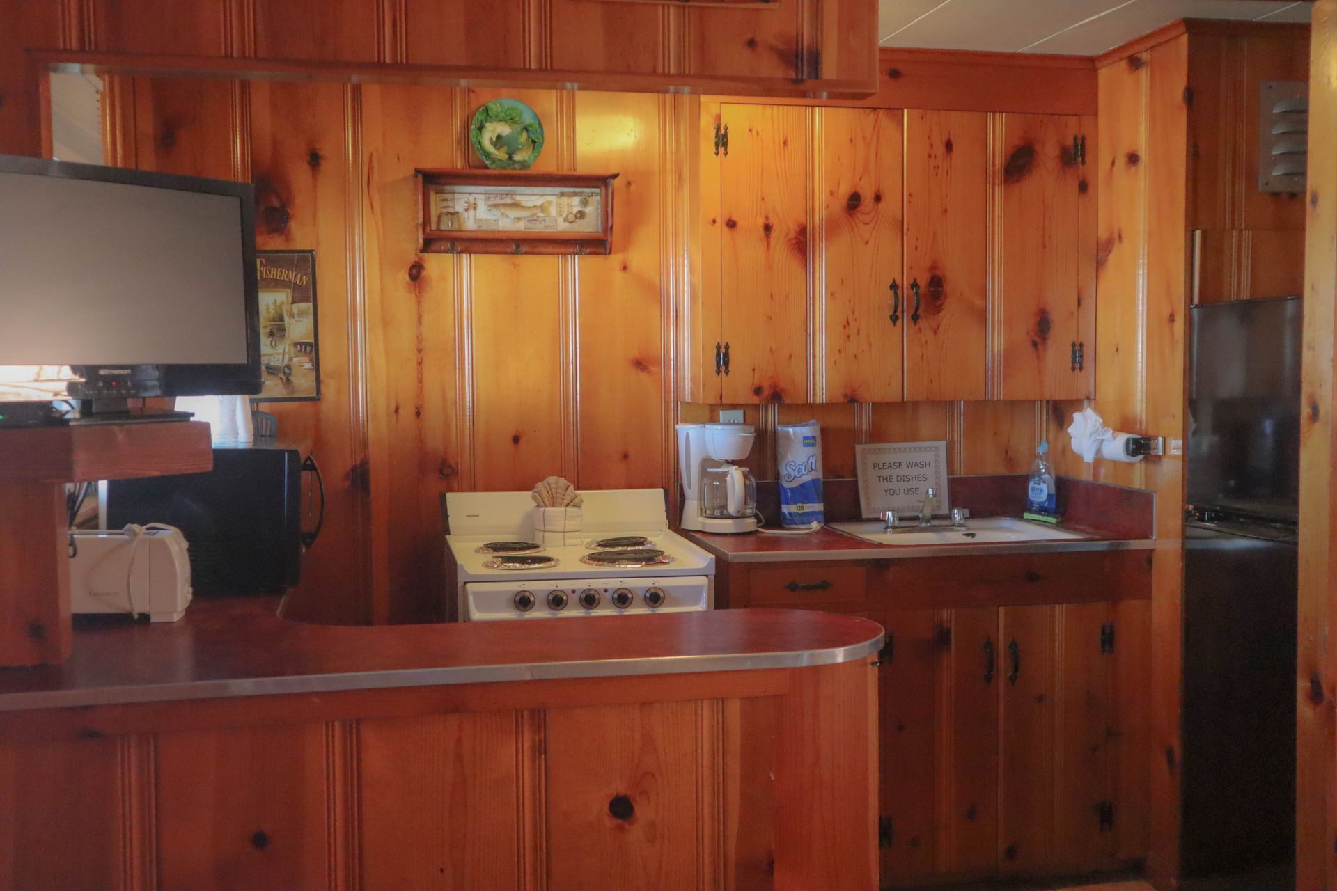 A kitchen with wooden cabinets and a stove top oven