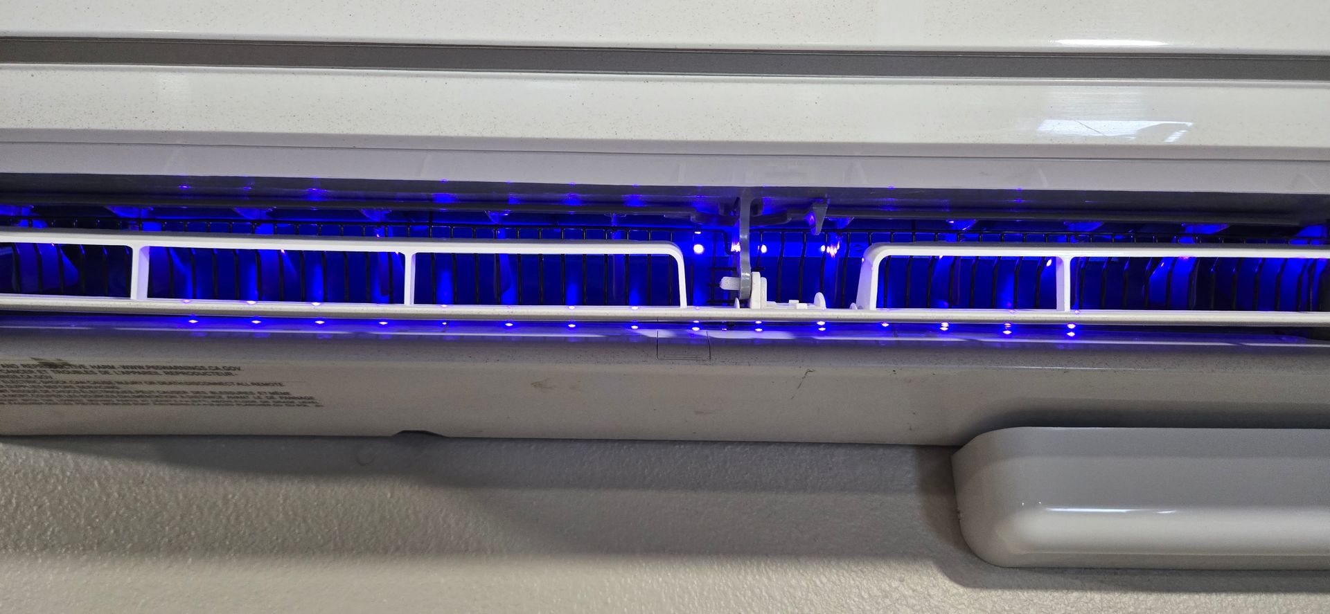 An air conditioner is sitting on the side of a brick building.