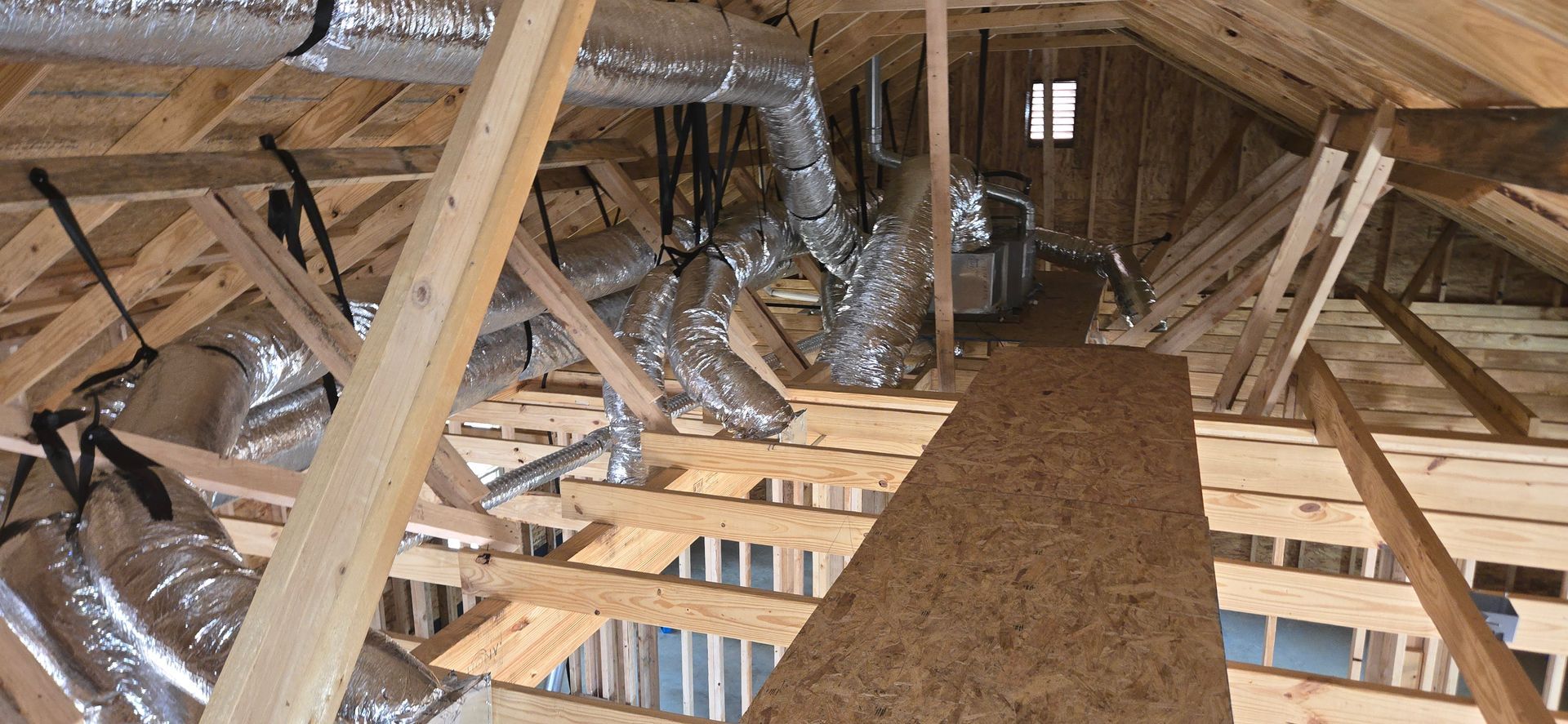 A wooden structure with a lot of pipes coming out of it.